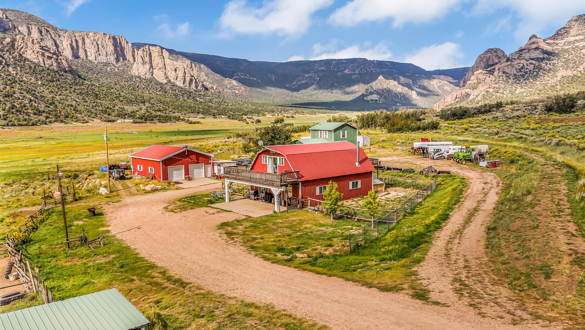 Breathtaking 360 degree Views, Area 61 Trophy ELk and Deer, Bear, Hunting Blinds, trails.Bring your outdoor toys. Grazing fields. Small Creek running through. Horse barn and corrals. Large 3 Bay Garage. Two Houses: a Primary home, and a Short-term Rental? Both Residences have their own Electric, Gas meter and Septic system, and they share a well.  Red Barn house: Very Rustic with Lots of Wood features and has 10 ft ceilings, tongue and groove wood planks on the ceiling and a massive kitchen with cupboards to the ceiling, plenty of extensive closets for storage upstairs. Two Second story decks one on each end of the house.Covered porch. New Water heater. Green House: has been completely remodeled with new kitchen, flooring and an extra large loft bedroom for complete privacy Includes 246 16 1/10 Rd.