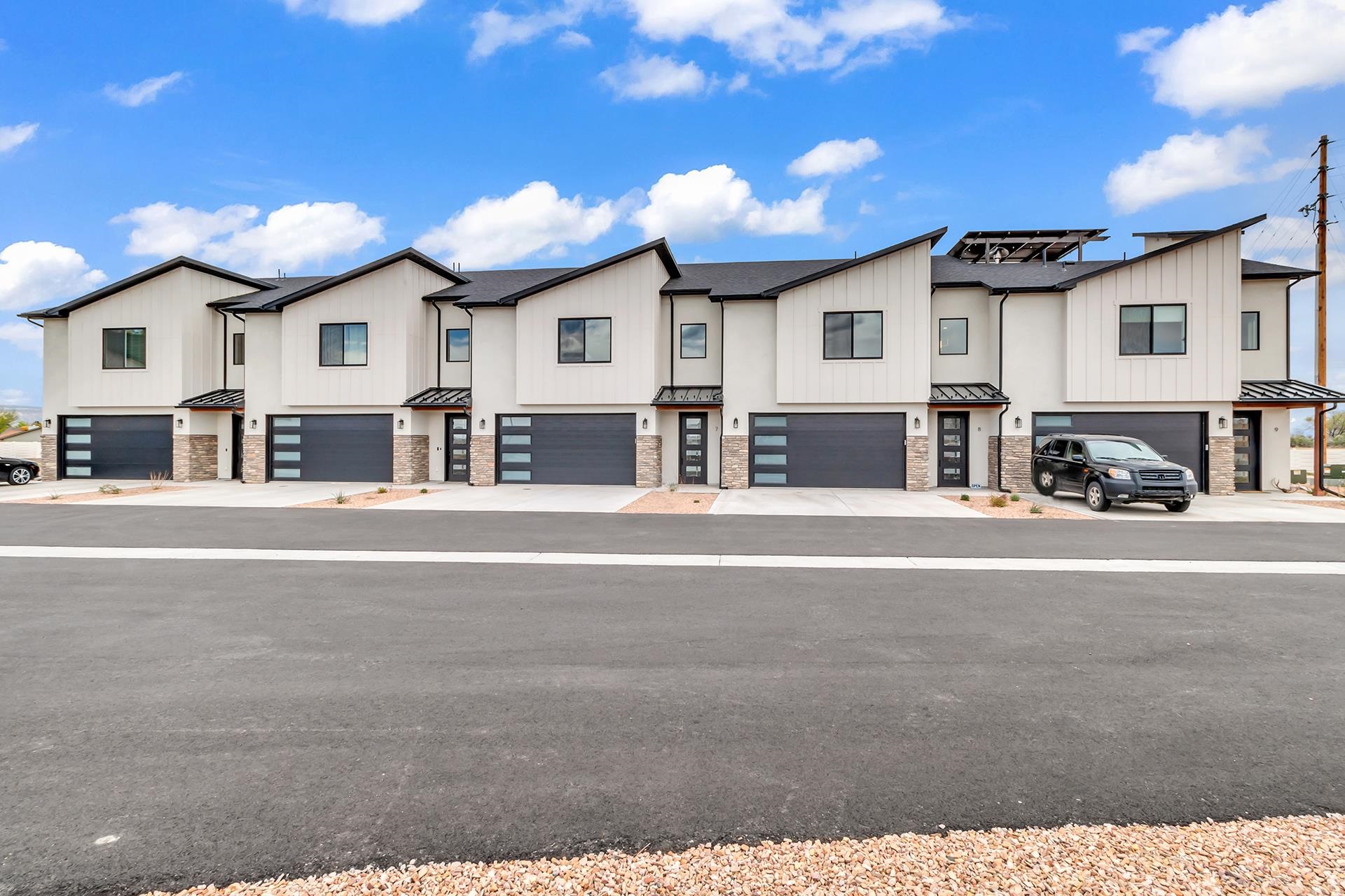 North Grand Junction's newest LUXURY townhome community offering premium finishes, sleek designs and premium location! These two-story units offer a modern, seamless design with premium interior and exterior finishes that will stand the testament of time and design! Grand entrance features a cathedral opening, boasting chandelier accent and large picture window letting in abundant natural lighting! LARGE open concept living and kitchen area provide the perfect space for entertaining and relaxing in comfort! The kitchen is ready for gourmet entertaining with large center island, premium cabinetry, granite countertops with deco backsplash and plenty of pantry storage. Bring the outside in through the large windows, and take your living outside to the spacious covered patio! Convenient half-bath on the main level will feature an accent wall (think shiplap, wood accent, deco paint, etc!) Access the upper level by way of floating-step staircase, which only adds to the open feel and modern touch. Spacious bedrooms upstairs all have plenty of closet space, including the primary bedroom that boasts HUGE walk-on closet and en-suite bathroom with dual vanities and custom tile walk-in shower! Front and exterior landscaping is complete and maintained by the HOA for you! Privacy fencing between and around units installed by Builder! Imagine opening up your glass door and stepping out to your patio to be greeted by amazing Grand Valley views every morning. Take in the grandeur of exquisitely sculpted grounds you don’t have to maintain. Flukey Estates’ modern spaces blend seamlessly with nature’s beauty to give you a home that truly lets the outside in.