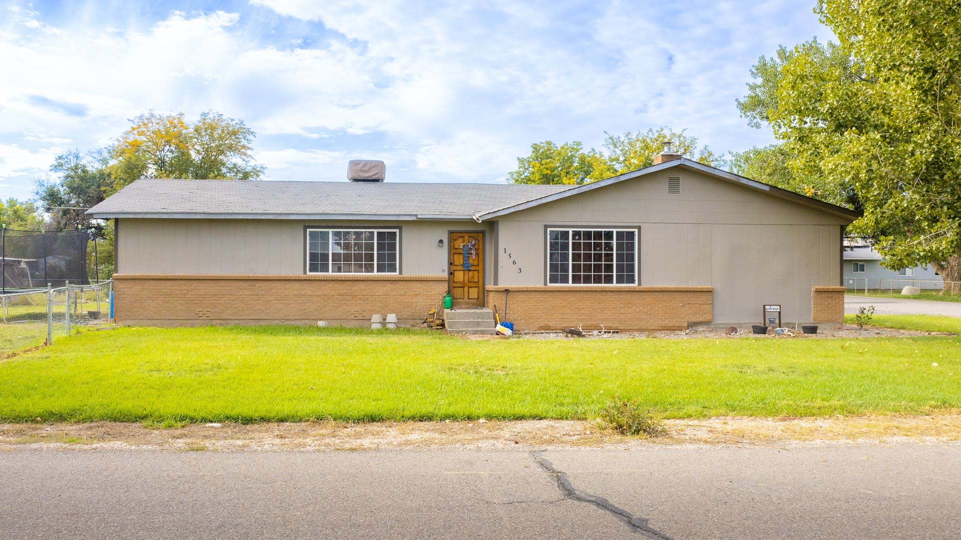 Awesome opportunity to own a home on almost 3/4 of an acre in Fruita for under $375,000! Don't miss out on this rare opportunity for this 3 bed 2 bath home on .62 acre lot with irrigation water. This home is full of potential and ready for the next owner to put their love into it. Bring your animals, no HOA, and a huge Fenced yard surrounded by large trees perfect for dogs and kiddos to get their energy out. Inside the kitchen is equipped with newer appliances and new carpet in the bedroom. The living room has an aura brought on by the wood burning fireplace perfect for cozy evenings in the winter. With nearly 1700 sq. ft. of living space, this home has the makings to be an incredible home for the next owners to make it theirs.