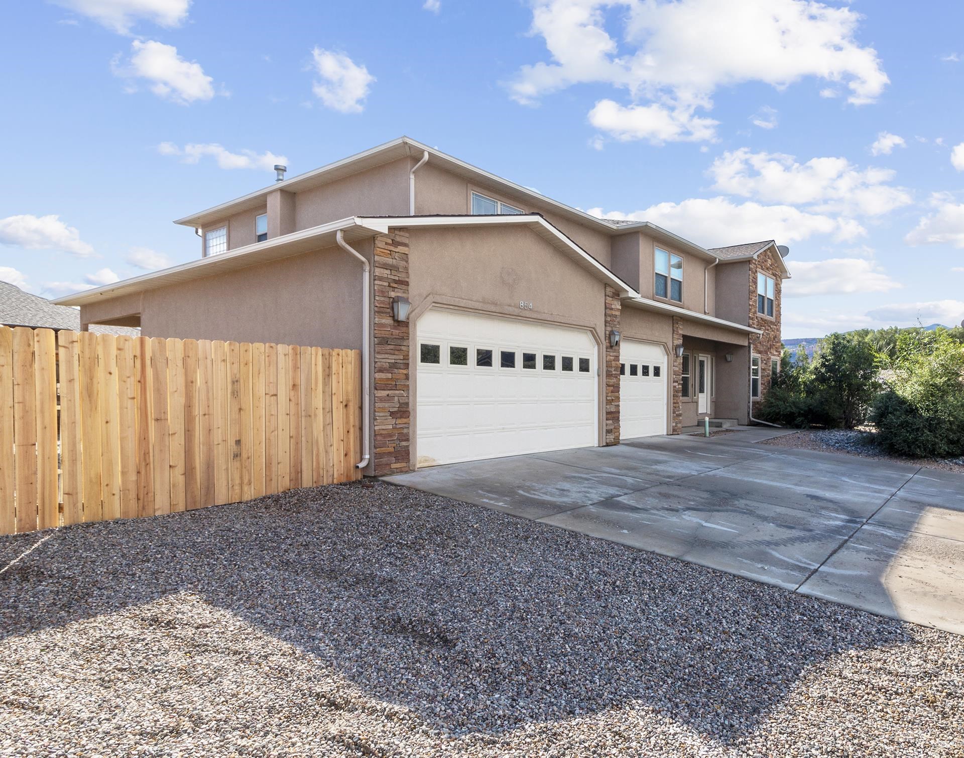 This beautiful custom two-story, 5 bedroom, 3 bath, 3 car garage home in Fruita is located in a quiet, peaceful cul-de-sac in the Santa Ana subdivision. Enjoy gorgeous views of the monument from the massive back yard after you come home to appreciate the high ceiling living space, formal dining, gas fireplace, and spacious main level!  Massive upper level master suite AND main level bedroom with its own entrance!  This unique home includes TWO laundry rooms (one main level and one upper level). This home is sure to check every box you have.  Recent upgrades include new carpeting throughout.  Just minutes from the Colorado National Monument's world class hiking and mountain biking as wells as downtown Fruita's shops and restaurants!  Additional amenities include granite countertops, covered patio area off of main-level bedroom, 5-piece master bath and much more! Call today to schedule a showing.