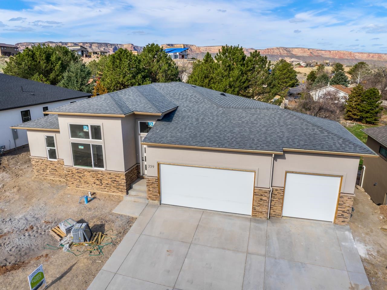 What an incredible opportunity to own a new build in the Redlands! Located in the Ridges area in Grand Junction, CO, this beautiful home has everything you're looking for and more! The main floor is open and airy with high ceilings and copious windows to highlight the views of the Colorado National Monument and surrounding areas. The kitchen is any home chef's dream and is open to both the dining and living area making for an excellent entertaining space, especially with access to the large covered deck. The primary bedroom suite is on the main floor and has a luxurious 4-piece bath attached, a large walk-in closet, and access to the laundry room. There is a second bedroom on the main floor with its own access to the 3/4 bath - a fantastic guest room, play room, or office space! You'll love the mudroom in the back hall with room for coats and shoes and storage. The walk-out basement is equally amazing and doesn't feel like a basement at all! Here you'll find an additional living space with large windows, two additional bedrooms, a 4-piece bathroom, and plenty of storage! The main living space on this level opens to a covered patio with more stunning views. The attached 3-car garage is on the main level, and offers plenty of room for parking, tools, toys, or hobbies. Located close to trails, Redlands Mesa Golf Course, the Colorado National Monument entrance, schools, shopping and more, you're never too far from anywhere in the valley. Don't miss your opportunity to live and play in Western Colorado - book your showing today!