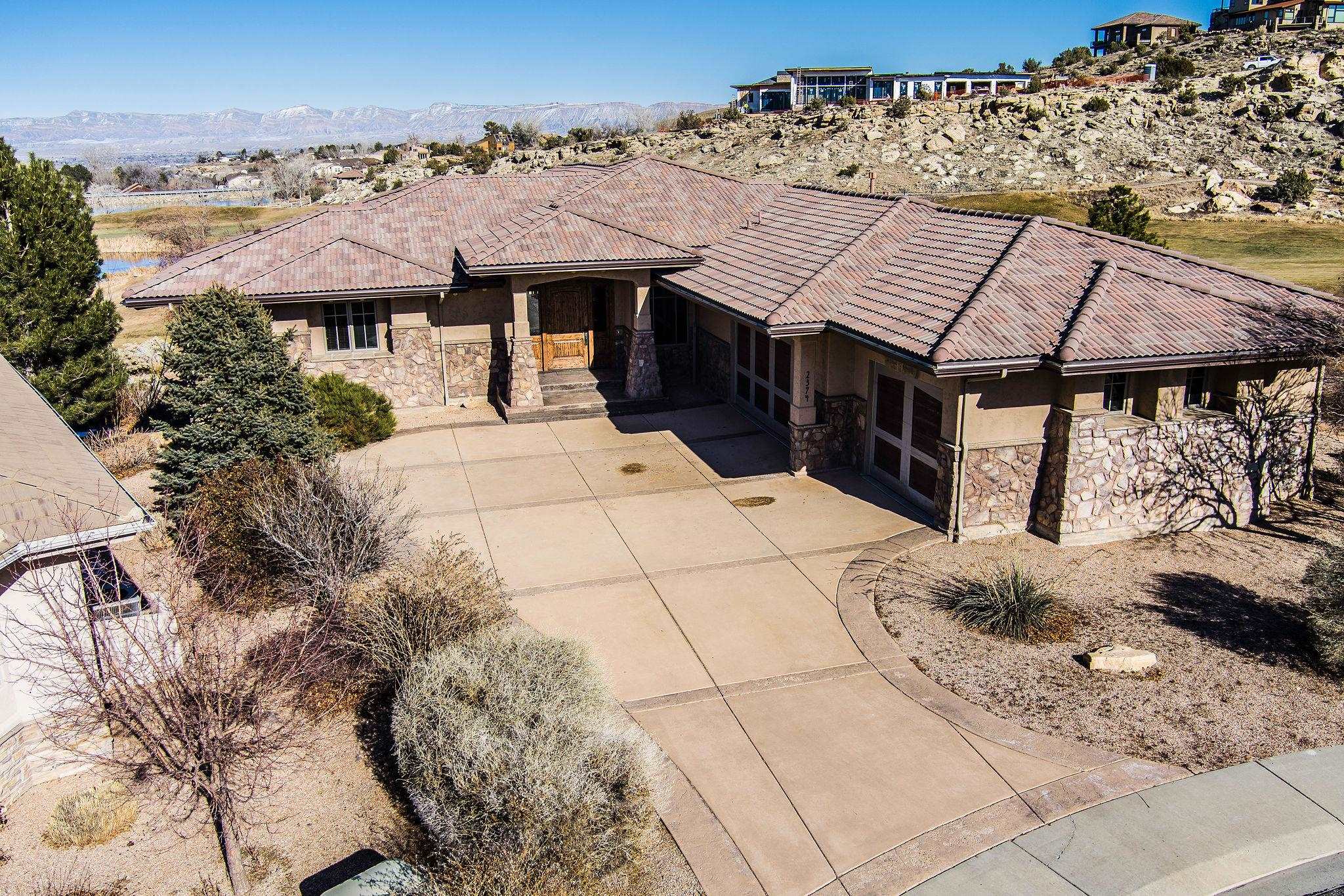 Redlands Mesa Golf Course, ranked #1 by both Golf Digest and Golf Week in the State of Colorado and this home looks right down the fairway for unobstructed views for miles!! This majestic ranch style home with a walkout basement, 4198 sq ft, 5 beds, 5 bath and oversized 3 car garage is perfectly situated on the lot! The massive hand hewn front door opens to 16 ft ceilings adorn with wood beam details and a wall of glass with a double sided fireplace. The kitchen is everything you would expect and continues the “REALLY” great room setup of the main level. Private office off the entry with built ins and storage, if you want to work from home. The master suite opens onto the upper deck and master bath and walk-in are nothing short of spectacular and needs to be seen to be appreciated. The basement has 3 bedrooms, exercise room, 2 bathrooms, wet bar area, and family/game room area! This entire home has been gone through and is ready for you to just move in and put your feet up...until you decide to hike, bike, play golf, go out to eat...you name it!! Book a private showing today, much more to see!!