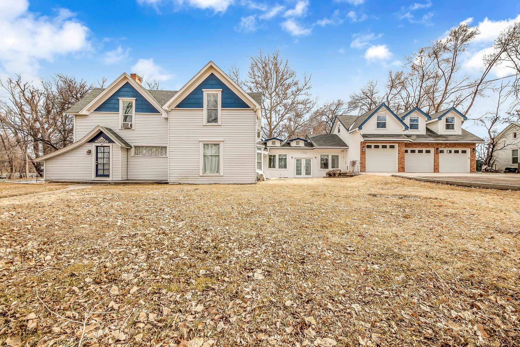 Located in North Grand Junction, the historic Willow Pond Estate will transport you to another time and place.  The mature landscaping  with willow tree surrounds a small pond on this beautiful 1.5 acre lot. The former bed and breakfast property, with its inside and outside entertaining areas, is currently used as a private residence but may have the option to be used as a B&B with event venue again.   Tons of natural light fill the home and the main floor primary suite with sitting room or office area features luxurious Ralph Lauren carpeting and a private entrance. The ground floor also offers a chef's dream kitchen with amazing built-in pantry and eating area, a brick fireplace hearth and stunning beams enhance the beautiful living room, and the home has timeless original hardwood floors. Built-in bookshelves, a breathtaking staircase at the homes entry, and a second primary suite upstairs along with 2 additional bedrooms and 2 more baths round out the historic part of the home.   Other features include a three-car attached garage, a breezeway that makes a great flex room with freestanding stove, an office area with built-ins, and an upstairs guest quarters above the garage showcasing a bedroom, bonus room (or additional bedroom) and a 3/4 bath.  In addition the 506SF carriage house has 2 - 1/2 baths with exterior entrances and a large studio space great for crafters, a home business, or possibly transformed into an ADU.  This historic property is the perfect place for you to create a dream home, see it in all its nostalgic beauty today.