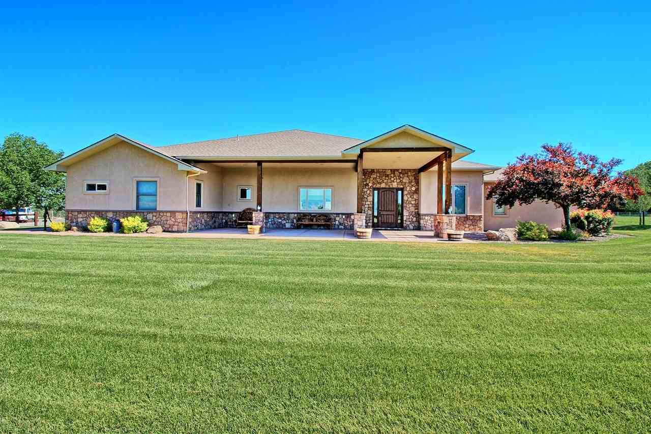 This custom built rancher on 16 acres provides a panoramic 360' views of the Monument, Bookcliffs and the Grand Mesa. This home offers a western flair with hickory flooring, beautiful exposed beams, stone fireplace, 8' alder doors, alder trim, and 12' and 10' ceilings throughout. No detail has been overlooked, from the 6 burner gas stove to the oversized windows framing amazing views. The home features custom alder cabinetry by Osburne, granite countertops, surround sound, custom made range hood & island light. Enjoy incredible sunrises and sunsets from your covered patios front and back. The property features a 1240 SF attached garage, a 2112 SF RV garage/shop there is unlimited storage and 40 X 100 metal building. The entire property is pipe fenced and irrigated. Ideal as a horse property or a private retreat! All information subject to change/error; buyer(s) to verify.