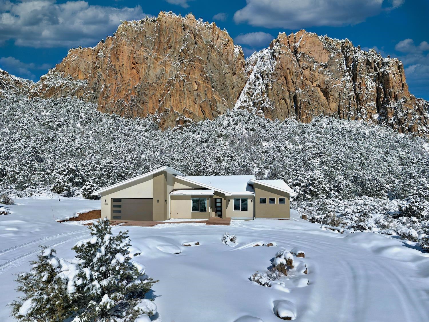 Custom built home in 2022 sits on 5.72 acres and backs to the Mothers Buttress rock climbing cliffs. Upon entering the home you are instantly greeted the towering granite cliffs out the oversized living room windows. If you look closely you might be able to spot a rock climber. The home boasts 2 master bedrooms with en-suite bathrooms. Plus there are 2 additional rooms and another full bathroom. The kitchen features quartz countertops, amble cabinetry, stainless steel appliances, and you can enjoy washing dishes while having pristine views of the cliffs. Outside enjoy the bbq, covered patio, and gas fire pit while gazing up at the stars. The property sits on 5.72 acres and is adjacent to BLM land on the NW side and the Western Colorado Climber's Coalition owns the Mothers Buttress rock climbing cliffs behind the house (there are restrictions which prevent WCCC from building on the land). The closest grocery store in Orchard Mesa is only a 30 minute drive. The home was built in 2022 and features a new septic system and good producing well. Don't miss this unique opportunity to own a piece of Unaweep Canyon! All furniture and supplies are negotiable.