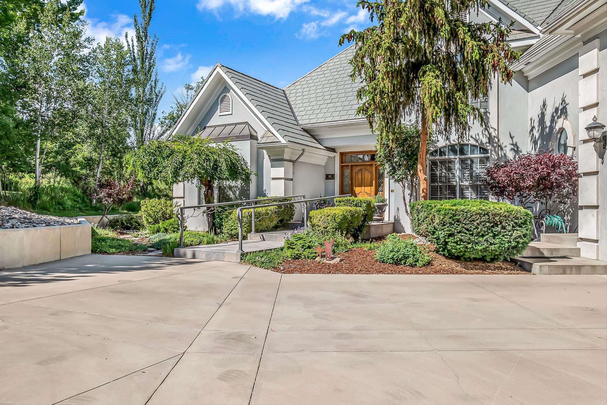 This is your new home - 5,956 square feet on 3.78 acres in the heart of Grand Junction! Enjoy the privacy and expansiveness of this property just minutes from downtown, hospitals, and the university. Incredible vaulted ceilings and floor to ceiling windows to accentuate the natural light and open views. Primary bedroom located on main level with large ensuite 5-piece bathroom and separate study. Kitchen has been updated and provides abundant counter space and cabinetry, complete with separate wet bar. Fantastic oversized bonus room upstairs that could serve as a theater, workout room, or rec room. The outdoor living is also at its finest with generous patio, fireplace, and grill area. You will not find another home like it, set up your showing today.