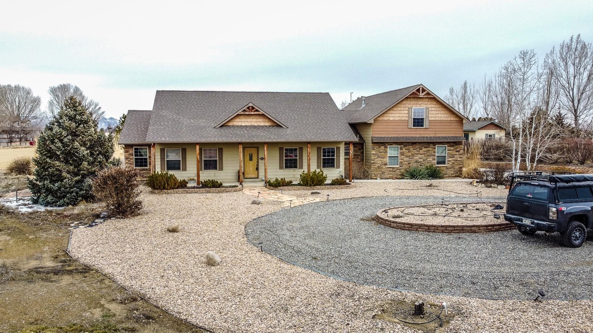 This beautiful Fruita home has so much to offer! Sitting on 2.83 acres, this 4 bedroom 3.5 bathroom home includes two living rooms, ample counterspace in the kitchen, a bonus room upstairs, and lots of natural light. This home also has great outdoor space. The east facing covered patio allows for enjoyable evenings in the shade. There are garden boxes with a drip system for those with a green thumb, a variety of fruit trees and RV parking as well. Take in the 360 degree views while enjoying the quiet sounds of being in the country but still close enough to ride a bike to downtown Fruita for the Farmer's Market in the summer. This home is ready for you to move in, sit back and enjoy!