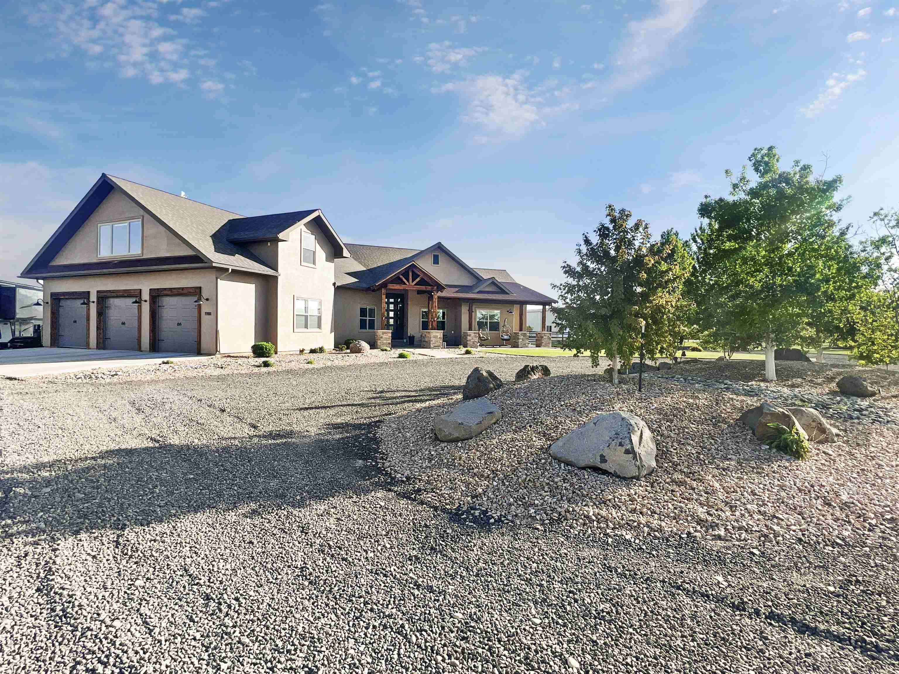 This STUNNING Maves Construction built home was featured in the 2013 Parade of Homes. Rustic Chic styling combines the rustic look Western Colorado loves with accents of modern design. This home will appeal to the most discriminating taste. Thoughtfully designed square footage with everything you would want in a home. Expansive kitchen with custom alder cabinetry features a steel grey stain accented by ivory alongside the 36" induction cooktop with custom designed hood. Pullouts throughout this kitchen will give you more storage than you will know what to do with in addition to the HUGE hidden walk-in pantry with prep sink and coffee bar. The home was designed with entertaining in mind, from the wide open living/dining/kitchen space to extending out to the covered stamped concrete patio with built-in BBQ and fireplace. Dining room with timber ceiling, modern fireplace wall and dramatic lighting. The primary suite is truly a sanctuary with a spa-like bathroom featuring multi-head walk-in shower and free-standing bathtub. Also on the main floor are two bedrooms, each with walk-in closets separated by a jack and jill bathroom, office/4th bedroom just off another 3/4 bathroom and large laundry with beautiful custom knotty alder teal cabinetry. Staircase with cable railing leads upstairs to a HUGE bonus room with wet bar/beverage cooler/microwave, 5th bedroom and bathroom. Situated on 2 acres giving you plenty of elbow room without feeling like you are in the middle of nowhere! Fully fenced dog run on side of house. RV Parking with hookups and waste dump! North facing patio provides you with dramatic sunset views of the Bookcliffs and Monument views out the front. Seller is licensed real estate broker in state of Colorado.
