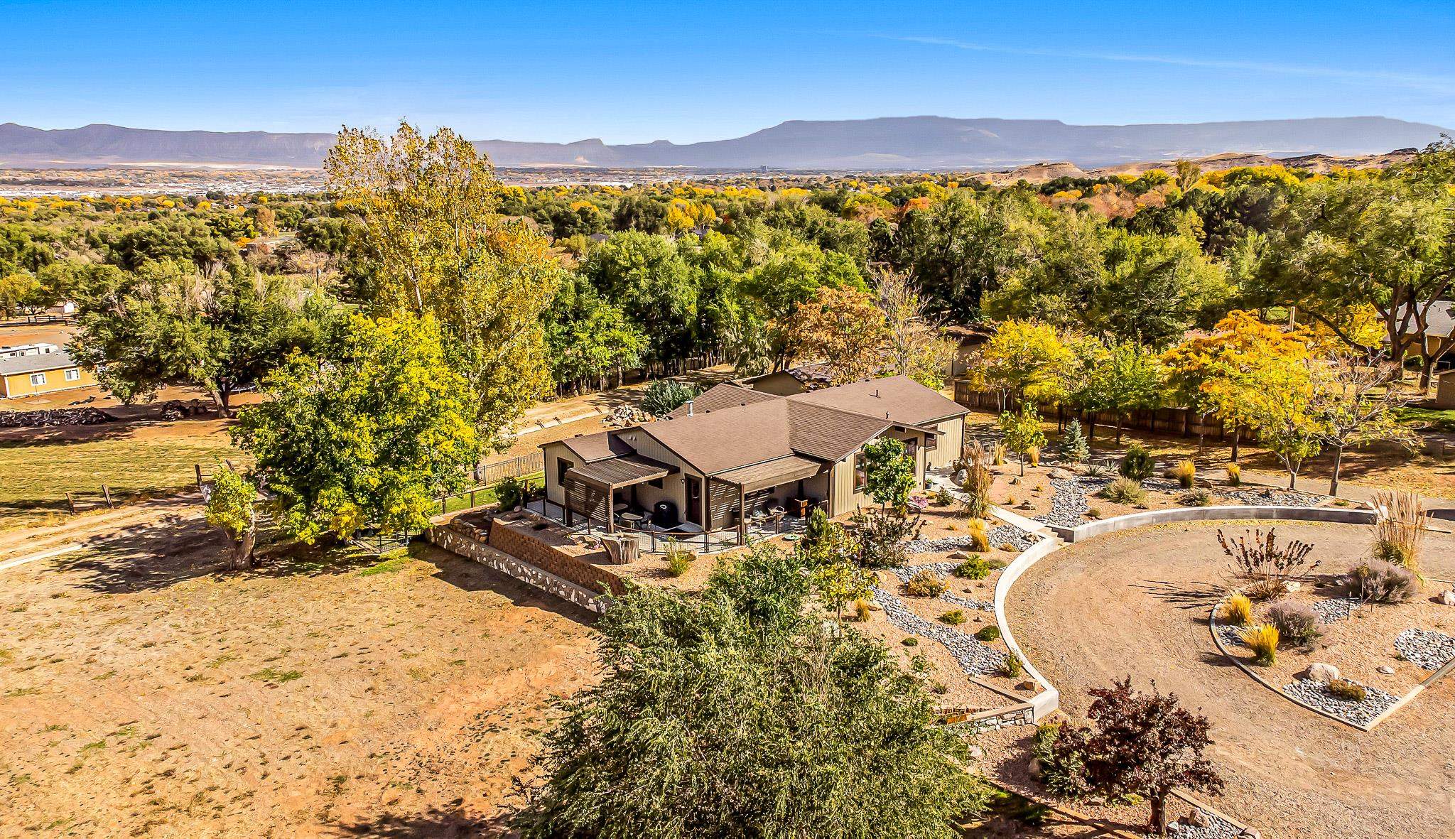 Truly, a one-of-a-kind property in the Redlands!  This 1.2 acre parcel is located at the base of the Colorado National Monument offering incredible views right out your front door!  Enjoy the sights of big horn sheep and take advantage of world class recreation right across the street!  As the property includes two shares of Redlands Irrigation Water and there is no HOA you are welcome to bring your horses and RVs, or build your dream shop in the available acreage adjacent to the home!  The exterior of the home blends beautifully with the Western Colorado surroundings, and the interior is well-designed with a touch of modernness and grace.  The home was recently remodeled and essentially re-built with new electrical, plumbing, HVAC, roof and septic, all in the last five years.  Featuring two main-floor bedrooms and bathrooms, the lower level offers a third bedroom, half bath, living room and additional flex space for an office, playroom or fitness room.  The detached 33’x25’ shop is heated and offers VRD and 220 outlets.  This property is such a great find, take advantage of the opportunity while it lasts – the location and views are amazing and unmatched!  All info subject to change/error, buyer to verify.