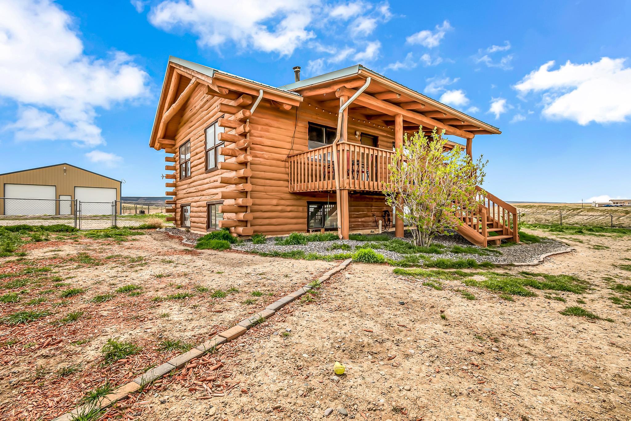 What a gem! You will be blown away by this Log Cabin home. Just minutes from downtown Grand Junction, the Grand Mesa, BLM land, and the Gunnison River. It's perfectly situated to captivate you with the amazing views. And plenty of land to call your own. You'll have ample space for all your toys with the large detached shop and the attached two car garage. Previously a 3 bedroom home, you may easily add the wall and have the extra bedroom if you feel the need to. With owned Solar, this can't be beat! Schedule your showing today!   *Home is Verified with Pre-Inspection taking place Monday and comes with a Buyer's Home Warranty at Close.