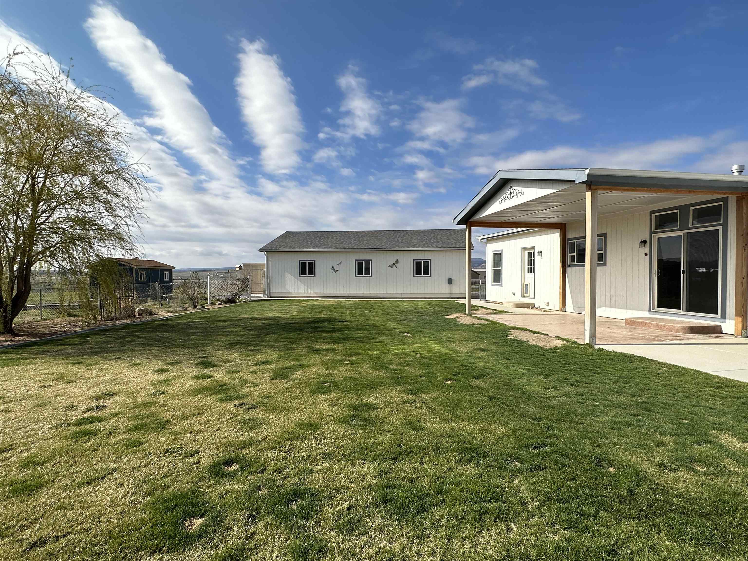 Here's your opportunity to own this beautiful 3 Bedroom 2 Bathroom split bedroom floorplan designed home on over 2 acres. The spacious living room includes a gas fireplace with open floor plan. Primary bedroom and bathroom include a walk in closet, shower and a soaker tub. The property includes a huge 4-car + detached garage, 2 storage sheds, dog run and plenty of RV storage. The front and back yards are irrigated and beautifully landscaped. Enjoy the 360 degree views of the Grand Mesa, Mt Garfield and the Monument from both the front covered porch & back patio areas! The home sits on a cul-de-sac.