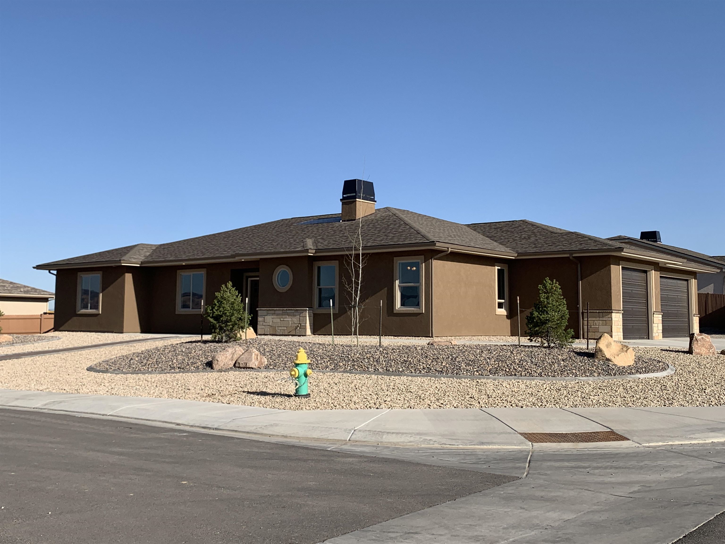 This "EMERALD II" Model is ideally situated on a 1/3 ac corner lot with views!  The split bedroom design includes an open floor plan living area with a spacious living (with gas fireplace), dining rooms and kitchen open and has great windows with view of the back covered patio and back yard area. The oversized 3 car garage with 9' ceiling heights and  16' & 9' wide x 8' tall overhead garage doors. Living area includes:  95% efficient HVAC system, 2x6 exterior walls, blown insulation, 9' & 10' ceiling heights, all kitchen appliances, and the front landscaping completed - ready for you to choose final backyard features.. room for a pool, putting green, or you decide.  Most of the 6' composite privacy fencing is installed.  Don't miss this great home in Emerald Ridge Estates