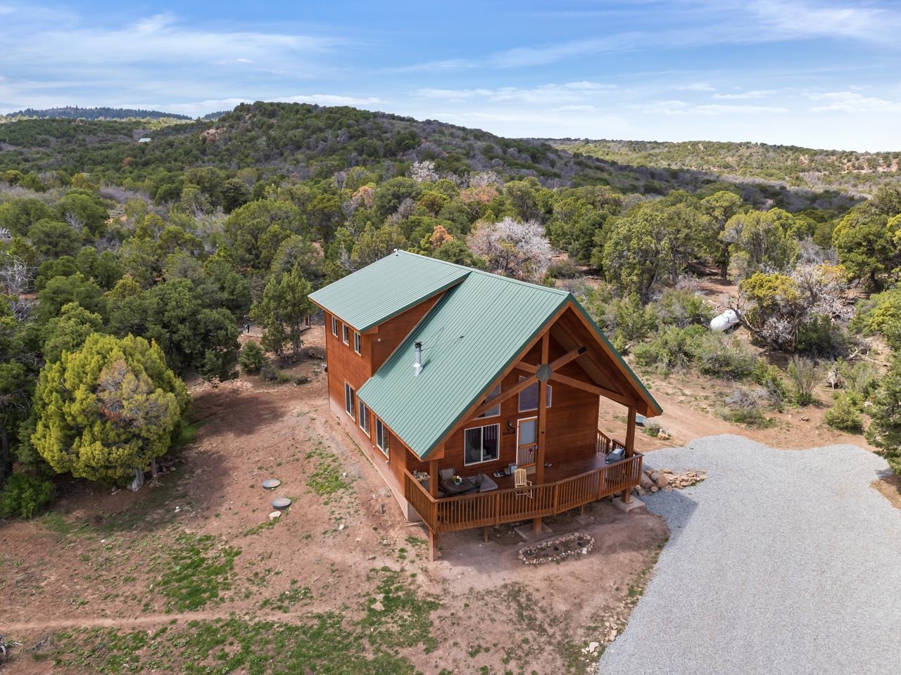 Welcome to your dream home in Glade Park, CO, a stunning property nestled on the Uncompahgre Plateau, just southwest of Grand Junction. Situated on over 42 acres of picturesque land, this beautiful home offers a serene and private retreat for those seeking tranquility and natural beauty. As you arrive, you'll notice the area cleared for riding corrals, perfect for equestrian enthusiasts. The property also features a detached one-car garage and a stable with two stalls and a hay/tack room, catering to all your horses (or other livestock) needs. The home itself is a true gem, boasting a bright and airy atmosphere that complements the surrounding landscape. From the covered front deck, you'll enjoy breathtaking views of the Grand Mesa, Bookcliffs, Mt Garfield, and other distant mountain ranges, creating a stunning backdrop for everyday living. Step into the main floor, where you'll find an open and spacious living room, perfect for entertaining guests or simply relaxing at the end of the day. The large dining area provides ample space for gatherings and everyday activities. The simple kitchen area is both functional and practical, offering everything you need for culinary endeavors. Additionally, a 3/4 bath, a bedroom, and a large laundry room, which also houses the solar controls, complete the main floor layout. Upstairs, the primary loft bedroom awaits, featuring a walk-in closet and offering a sense of privacy and tranquility. Step onto the large deck off the loft, where you can soak in even more panoramic views and enjoy the fresh mountain air. The property offers plenty of room for RV parking, catering to your outdoor adventure needs. During the winter, you can rely on the fireplace and two wall heaters to keep you warm and comfortable and there is a covered storage area for wood behind the garage. Additionally, there's a wood stove in the garage, providing extra warmth while you work on projects. With an elevation of 7,000 feet, the home benefits from cooler summer temperatures, eliminating the need for a cooling system. Despite the peaceful seclusion, the amenities of Grand Junction are conveniently located less than 30 minutes away. The scenic drive to the city is a delight in itself, showcasing the natural beauty of the area. Experience the beauty of nature, the tranquility of the plateau, and the convenience of nearby amenities. Schedule a viewing today and start living your dream life in this exceptional home. Do not follow Google Maps