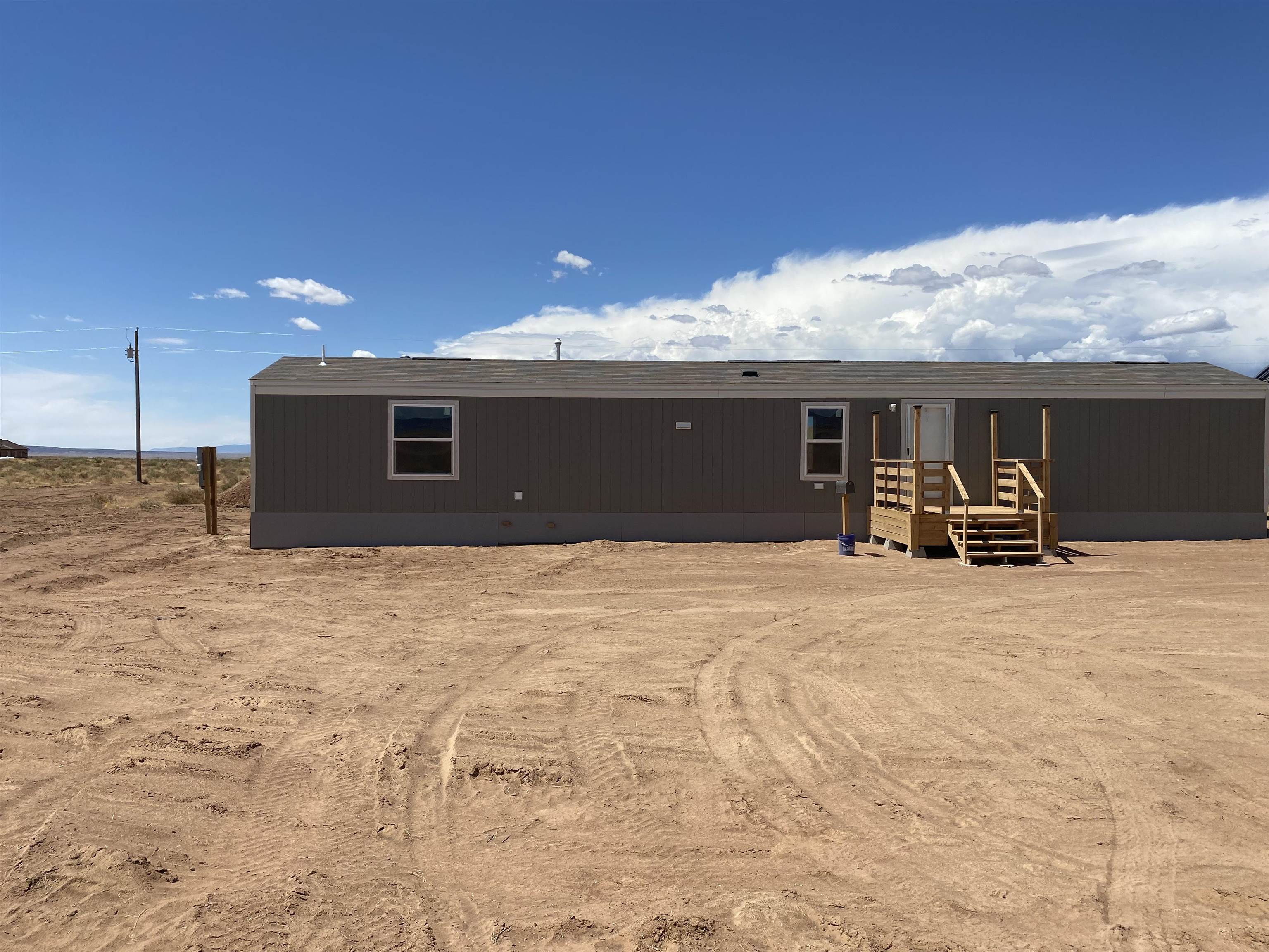 Brand new Clayton home is on the loma lot and can be viewed, This home has a brand new septic and cistern system installed as well. {there is a water filling station in loma for cisterns, average water less than $20.00 a month } Pictures are from the model on the Clayton lot but finishes and floor plan are the same. There is plenty of land to do whatever your heart desires. Prime location! Far enough out of town to feel like country living but still close to Fruita for convenience!!!  (The driveway to be graveled prior to closing , also  it is Possible to split the land on either side of the road into equal parcels.}