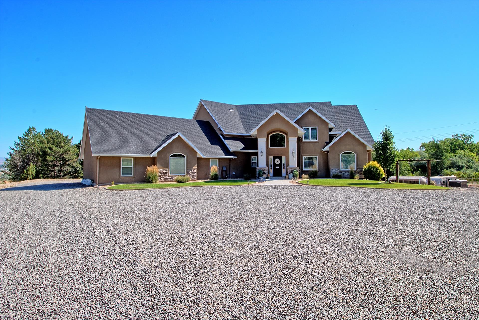 Welcome to 2248 Saddlehorn Rd. This stunning home is nestled on 1.24 acres and offers 6184 sq ft of living space with an amazing walk out basement. The property offers ample room for exploration and relaxation. The meticulously landscaped yard, mature trees, upper deck, covered patio, and an oversized gas fire pit are perfect for hosting outdoor gatherings. With such an expansive lot, you have the freedom to customize the outdoor space to your heart's desire, whether it be adding a pool, a playground, or a shop. This exceptional home extends its remarkable features to the interior as well. The main living area boasts a spacious and well-designed floor plan, ensuring plenty of room for all your indoor activities. The open concept design connects the living room, dining area, and gourmet kitchen, creating a perfect space for entertaining and everyday living. The home also includes an amazing primary retreat featuring a spacious layout, an en-suite bathroom, the walk-in closet of your dreams, and direct access to your outdoor deck to relax and enjoy your great Redlands views. Upstairs, you'll discover the exceptional design element of loft spaces in 3 bedrooms. These loft areas provide versatile additional space, allowing for various uses such as home offices, reading nooks, or play areas. They add an extra layer of functionality and charm to the already impressive bedrooms. With a total of 5 bedrooms, 5 bathrooms, 2 living spaces, 2 offices/dens, 2 kitchens, 2 laundry rooms, numerous storage options, and an oversized 3 car garage, this home offers ample accommodation for family members and guests. Each bedroom is thoughtfully designed to provide comfort and privacy, while the bathrooms are equipped with modern fixtures and finishes to enhance your daily routine. However, what sets this property apart is the potential it offers in the basement. With its own separate entrance, complete with a bathroom, kitchen, and laundry facilities, it can serve as a private retreat for guests, a multi-generational living space, and other endless possibilities.  Conveniently located in the sought-after 81507 area, this home provides easy access to a range of amenities. Outdoor enthusiasts will appreciate the nearby hiking and biking trails, while golfers will find themselves in proximity to golf courses. Shopping, dining, and entertainment options are also nearby.  Don't miss your chance to experience the best of Colorado living in this remarkable residence.