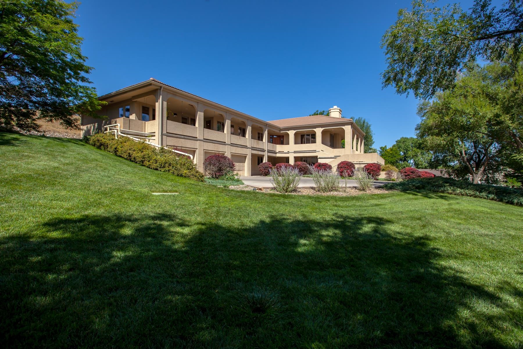 Step inside and feel welcome in this prestigious, handicap accessible home with its very own elevator! Upper level consists of large living room with fireplace, windows that bring in the natural light and a formal dining area combined. Kitchen comes with an amazing pantry, island, large refrigerator and double ovens. Family room also has plenty of natural lighting with built in cupboards for plenty of storage and door to the outside porch. Oversized primary bedroom has an abundance amount of space with a wall of windows, absolutely amazing walk-in closet, door out to the front porch and more than enough room in the primary bathroom which includes a vanity area. 2nd bedroom would be perfect for a studio or exercise room with a great amount of closet space, including a walk-in closet and an office area. Also walk-outs to the front porch. 2 additional bathrooms along with the oversized laundry room with plenty of cabinet space plus a shower/wash area for your pet are located on the upper level. Main level has 2 very nice size bedrooms each with a wall of windows for that natural lighting, a large office area or craft room & sitting room off of one of the bedrooms, which could also be a small bedroom. Small room with sauna would also make a great exercise room and is where the elevator is located. There are also a full bath and a 3/4 bath on this level. Full bath has entrance directly to the sauna. Home is handicap accessible with a ramp from the garage into the main level with wide halls and access to the elevator which goes to the upper level and opens to the front entrance. Large storage room located next to the garage for all of your what-nots! Sit out anywhere on the beautiful front porch with your favorite beverage and enjoy the views of the luscious green lawn, trees, birds and wildlife. Very serene location with beautiful Colorado National Monument backdrop!