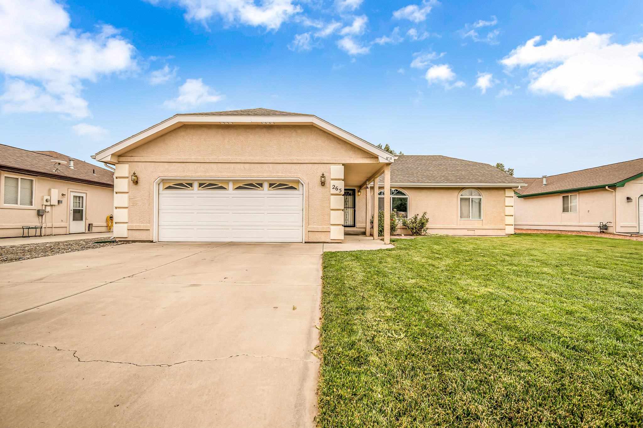 Easy Fruita living is calling! This beautiful home, situated on an immaculately maintained lush green lawn with mature trees and rosebushes offers the quiet & privacy of a cul-de-sac within a short walk or bike ride to the community center & all that downtown Fruita has to offer. Lots of natural light pours in through large windows into vaulted ceilings in the main living area, which flows easily into the dining and kitchen spaces. The kitchen features high end stainless Samsung appliances and a bay window, providing a view out onto the beautiful back yard. The covered patio allows for extra room to grill, entertain or just sit and enjoy the outdoors. The split floor plan provides for a spacious primary suite, complete with a 5 piece bathroom, on one end of the home & 2 more large bedrooms and a full bath on the opposite end. 2 large sheds in the back yard, shelving & cupboard units in the garage & space to add RV parking next to the home provide plenty of options for storage. Bonus: Brand new washer & dryer also stay! Come see this one today!