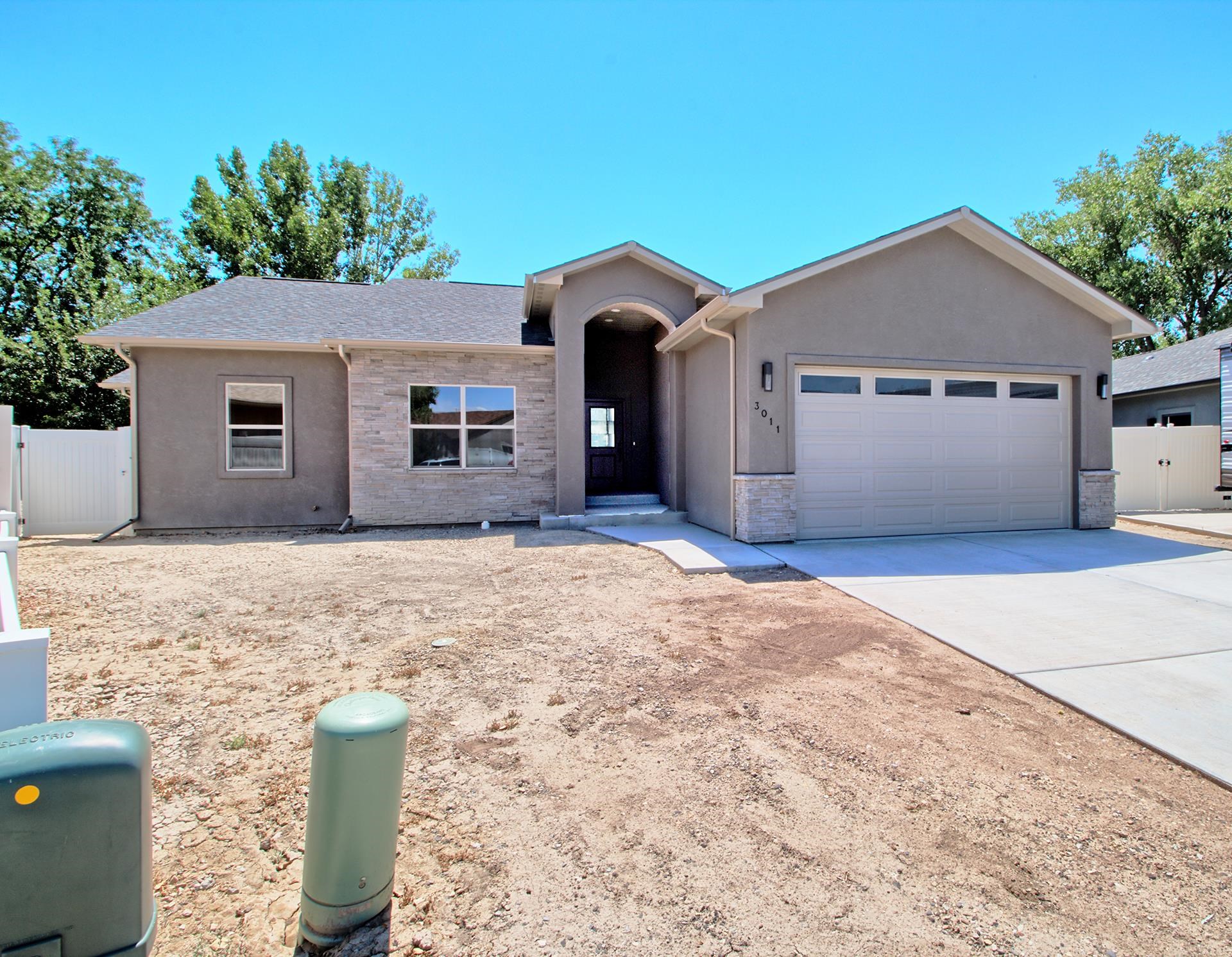 NEW CONSTRUCTION in Apple Acres subdivision! This stately home features SO many upgrades and premium Builder finishes; sure to delight the discerning Buyer! Easy-maintenance stucco exterior with stacked rock accent make for attractive curb appeal. As you walk in the font entrance, you're greeted by the expansively open & bright living room, with vaulted ceilings, new LowE windows and stone surround gas-log fireplace with granite-clad hearth and seating space which adds additional dimension, charm and ambiance to the relaxing space! Chef's kitchen offers plenty of cabinet storage, stainless steel appliances and the same durable granite counters with under mount sink and large pantry with abundant shelving! Laundry room sits adjacent for added convenience and features overhead cabinets for private storage. Solid-core Knotty Alder doors and matching trim run the entire length of the home to add increased durability and contrasting aesthetics! Enjoy the spacious primary suite that offers large walk-in closet storage! Access the en-suite bathroom though the modern sliding barn door and features dual vanities, corner soaker tub, OVERSIZED walk-in shower with bench seating and custom wall and pebble-pan tile, and private lavatory closet. Two additional bedrooms share full bath, complete with tub/shower combo + glass door enclosure and linen closet storage. Enjoy the Grand Valley climate relaxing out on the expansive concrete patio that features covering over the sliding glass door and stairs for sun protection and full vinyl privacy fencing already installed! Home comes with 1-year Builder's Warranty for added Buyer confidence and enhanced peace-of-mind!