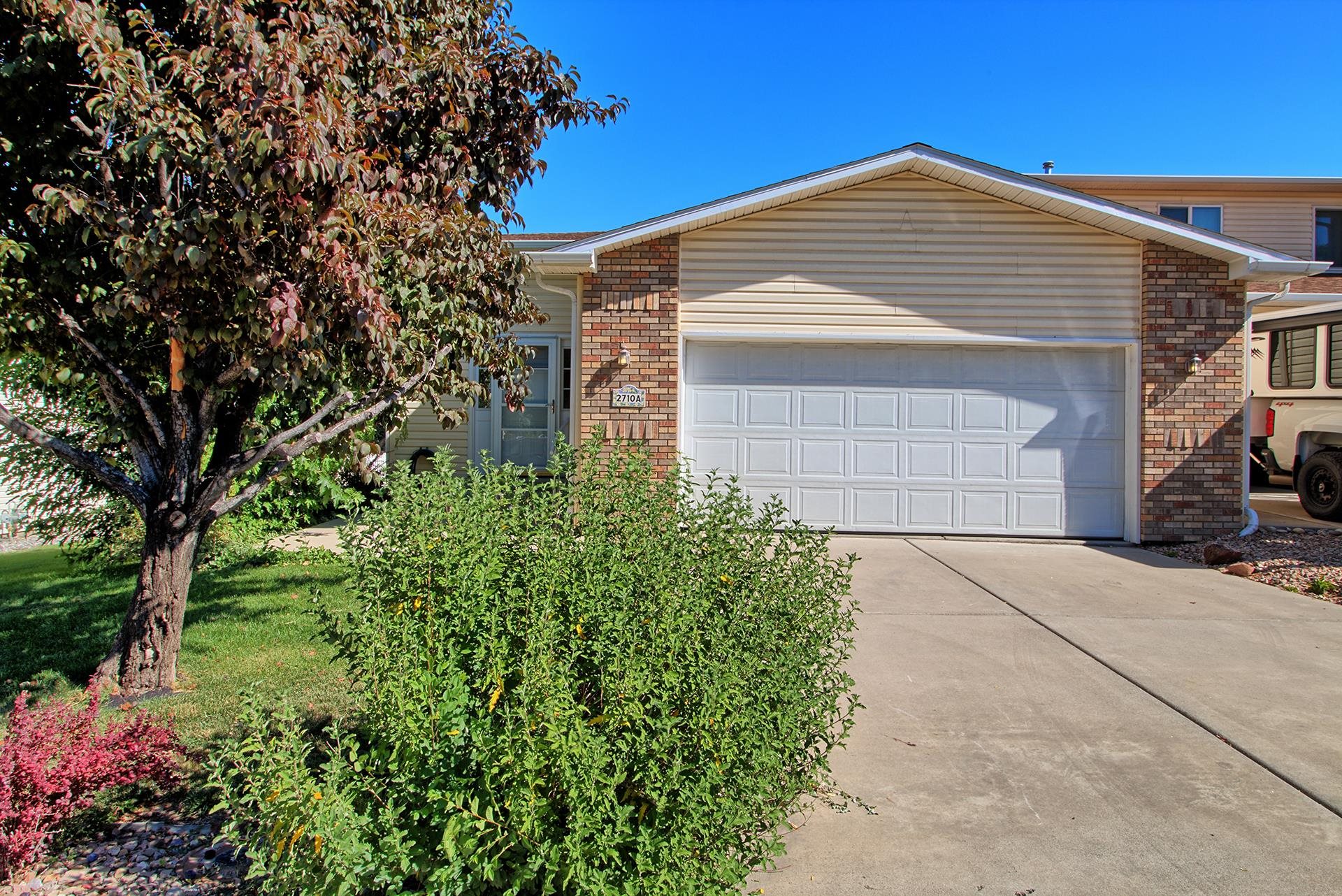 Great Lock & Leave end unit Townhome that is close in proximity to medical, shopping, recreation, I-70 and CMU. Light bright living space! The kitchen with breakfast bar allows the cook to be a part of any event also features a skylight. Off of the living area there is a Deck made of Trex-decking large enough for bar b ques & sitting w/ views of the mountains. This home features 2 large bedrooms, 2 ½ bathrooms, 1,450 sq ft and an attached 2 car garage. Nice little fenced in back yard for your pets.  Come and make this your home today!