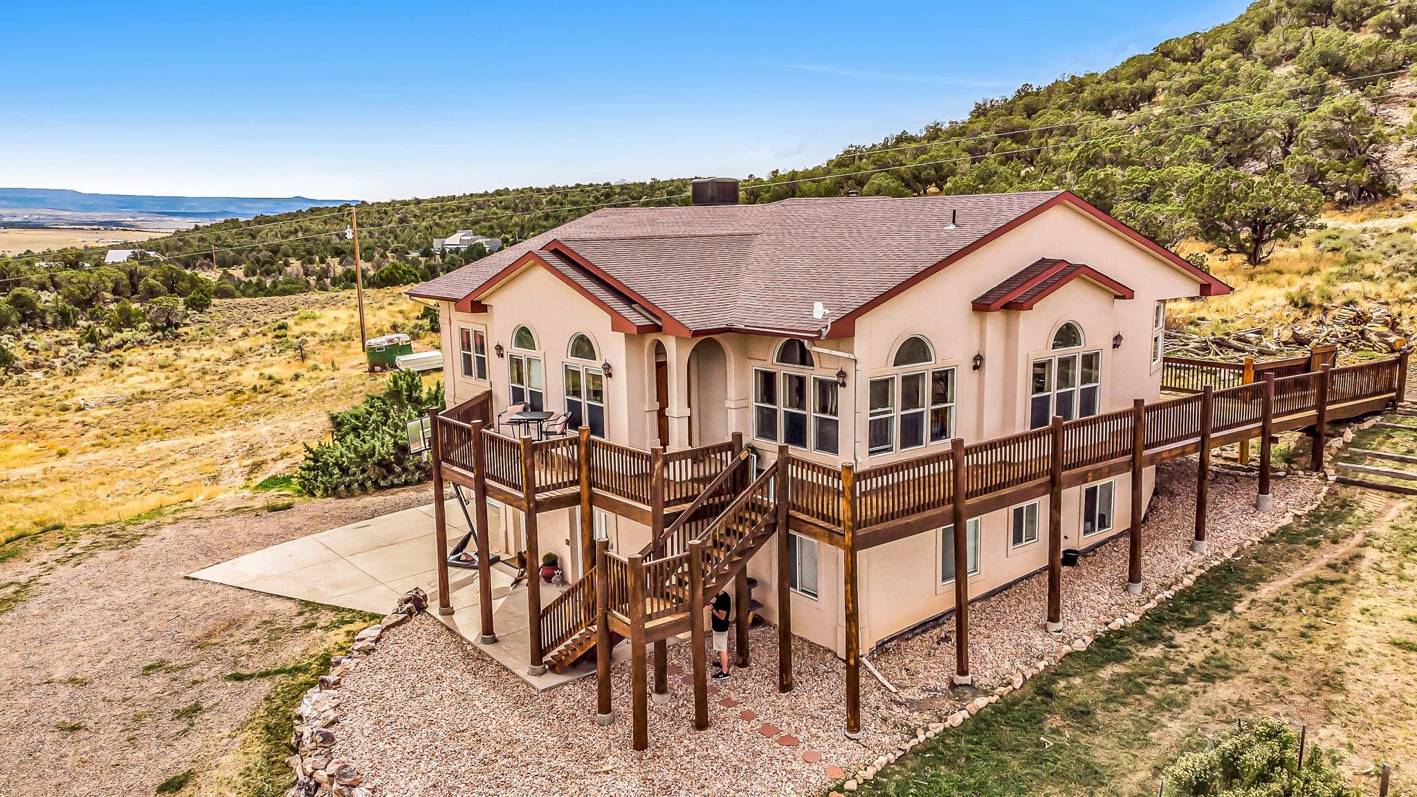 Discover your own piece of paradise in the heart of Glade Park, Colorado with this magnificent 4-bedroom, 3-bath home sprawled across an expansive 37-acre oasis. This stunning property offers a unique blend of spacious living, Airbnb potential, and pristine natural beauty. As you approach this home, you'll be greeted by the serene beauty of Glade Park, where fresh mountain air and endless skies create a picturesque backdrop. Nestled amongst 37 acres of tranquility, this property is a true Colorado dream. 4 bedrooms and 3 baths offer ample space for family and guests. The open and spacious layout is perfect for gatherings and entertaining. The expansive 37-acre lot provides privacy and room to roam. Enjoy breathtaking views of the Colorado landscape from every angle. Glade Park offers a peaceful, rural lifestyle while still being close to amenities in Grand Junction. One of the most remarkable features of this property is its direct access and boarders BLM land. You'll have endless opportunities for outdoor adventure, whether it's hiking, biking, or simply exploring the vast wilderness right at your doorstep. The heart of this home is its inviting wood-burning stove, perfect for cozy evenings during Colorado's winters. It not only adds warmth but also creates a rustic, charming atmosphere. The downstairs of this home is a versatile space often utilized as an Airbnb rental. With its separate bedroom, family room, kitchenette, and full bathroom, it offers privacy for guests while generating rental income. You'll find it beautifully appointed and ready for hosting. Peace of mind comes easy with this property as it has been pre-inspected, and many of the inspection items have already been expertly corrected. This means you can move in without the usual worries that come with homeownership. Don't miss the chance to make this exceptional Glade Park property your own. Whether you're seeking a private retreat or an income-generating Airbnb opportunity, this home offers the best of both worlds. Schedule your showing today and experience the Colorado lifestyle you've been dreaming of. Square footage differs from MCA. Seller believes the correct sq. Ft. to be around 3300.