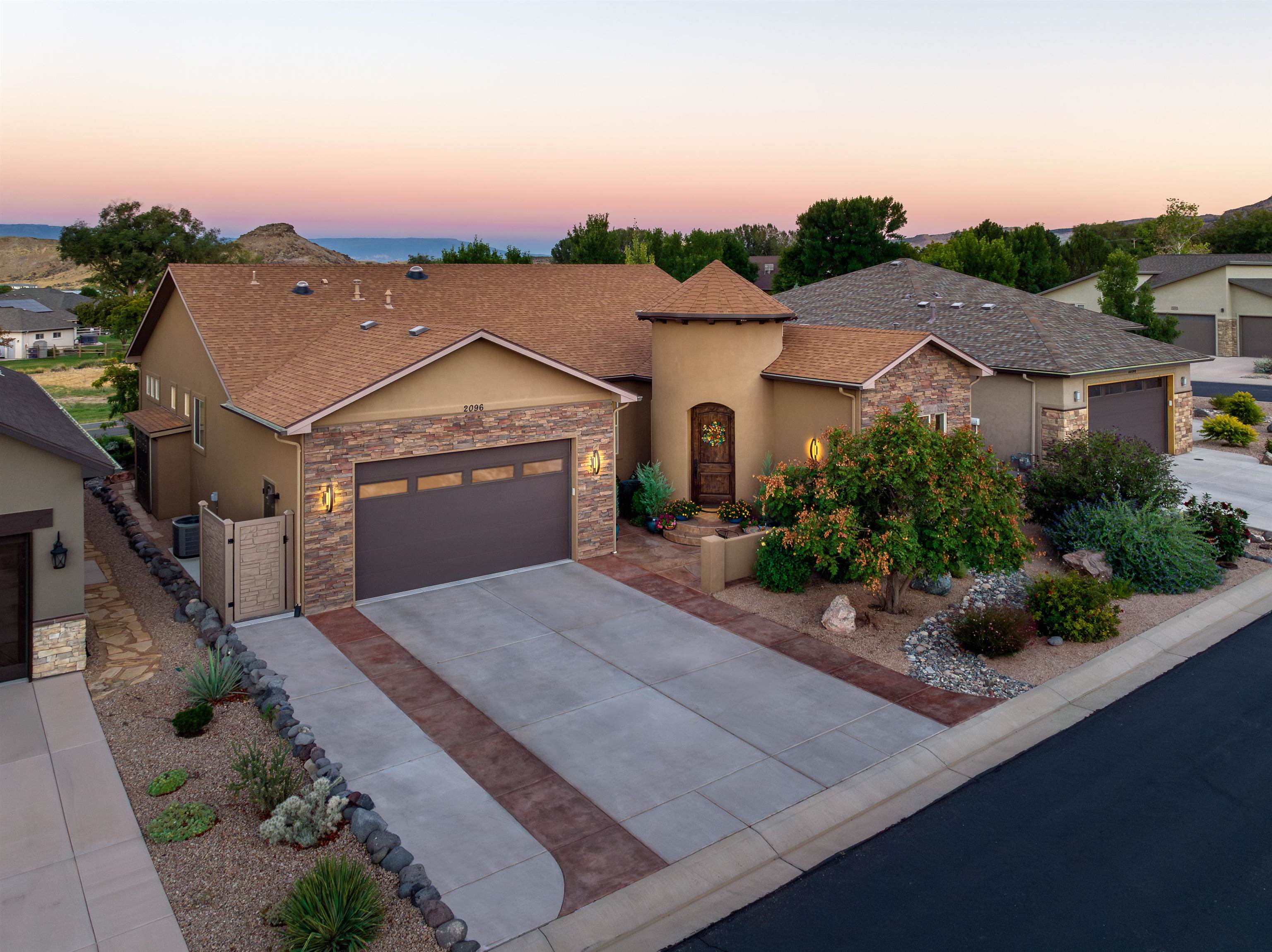 Custom build by Fisher Construction in the highly sought after neighborhood of Fairway Villas. Copious outdoor activities await you with this inciting location. The subdivision is adjacent to the Tiara Rado Golf Course, steps away from the Kindred Reserve open space park, and only minutes to the hiking trails on the Colorado National Monument. Enjoy the stunning red cliffs of the Monument from the courtyard located in front of the home. Impressive stamped and stained concrete leads you from the driveway all the way to the front door. Upon entering a 22' entryway welcomes you into this stunning home. Vaulted and tray ceilings stretch overhead. Natural light flows in from windows and recently added sun tubes. Granite counter tops, and stainless appliances in a kitchen that was made  for entertaining. adjacent  to the kitchen is an area flexible for a study, den or formal dining area. The possibilities are endless. The primary en-suite is bright and inviting with fresh tile and heated tile floor. The back patio boasts an expansive Trex deck, ceiling fans and retractable shade screens for ultimate comfort and privacy. Step inside for your private showing today!