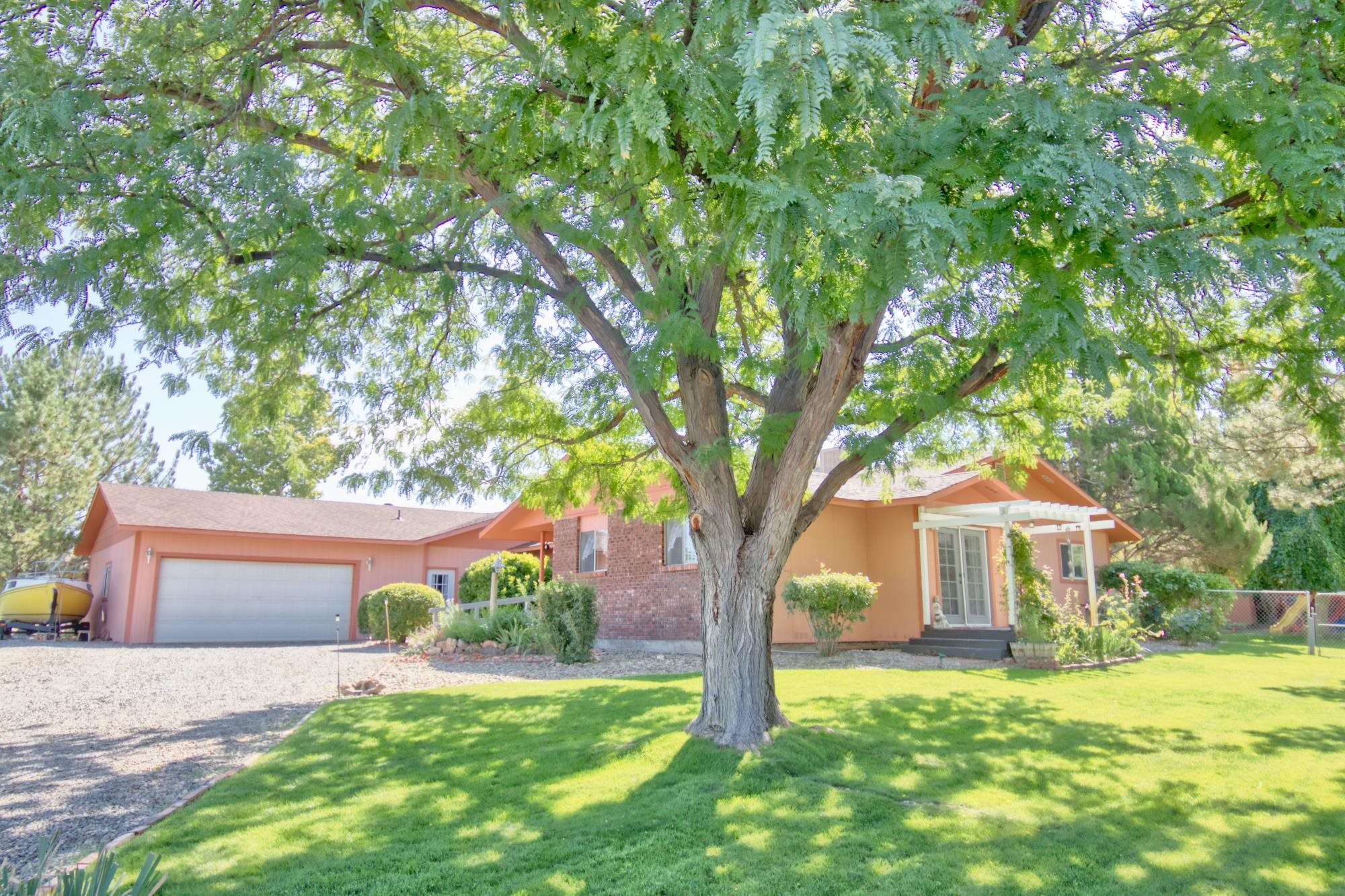 Welcome to this charming ranch-style home that boasts a generous 2,774 square feet of living space, featuring 4 bedrooms and 3 bathrooms, all thoughtfully situated on a sprawling .57-acre corner lot. Large windows invite an abundance of natural light, infusing the home with warmth and a sense of spaciousness. The kitchen features modern appliances, ample counter space, and abundant storage, creating an ideal setting for both everyday living and entertaining. The primary bedroom is designed with accessibility in mind, making it a sanctuary for relaxation and comfort. The ensuite bathroom is both spacious and accommodating, providing ease of use for everyone. This property offers an array of amenities that enhance your Colorado lifestyle. A fenced-in backyard provides a safe and private space for outdoor activities, while the 2-car garage ensures convenience and protection for your vehicles. An additional dwelling unit opens up possibilities for extra income, a home office, or guest accommodations. The .57-acre corner lot features mature fruit trees and maintained lawn and landscaping. This oasis invites you to enjoy the outdoors, whether you`re lounging in the shade of the trees, gardening, or simply relishing the beauty of your surroundings. You`ll be just moments away from hiking trails, a national monument, and all the recreational opportunities that the area has to offer. Yet, you`re also conveniently close to shopping and schools, making daily life a breeze. This home truly embraces the essence of Colorado living, with the rugged beauty of the landscape serving as a constant backdrop to your daily life. Don`t miss the opportunity to make this your forever home. Call and schedule your showing today!