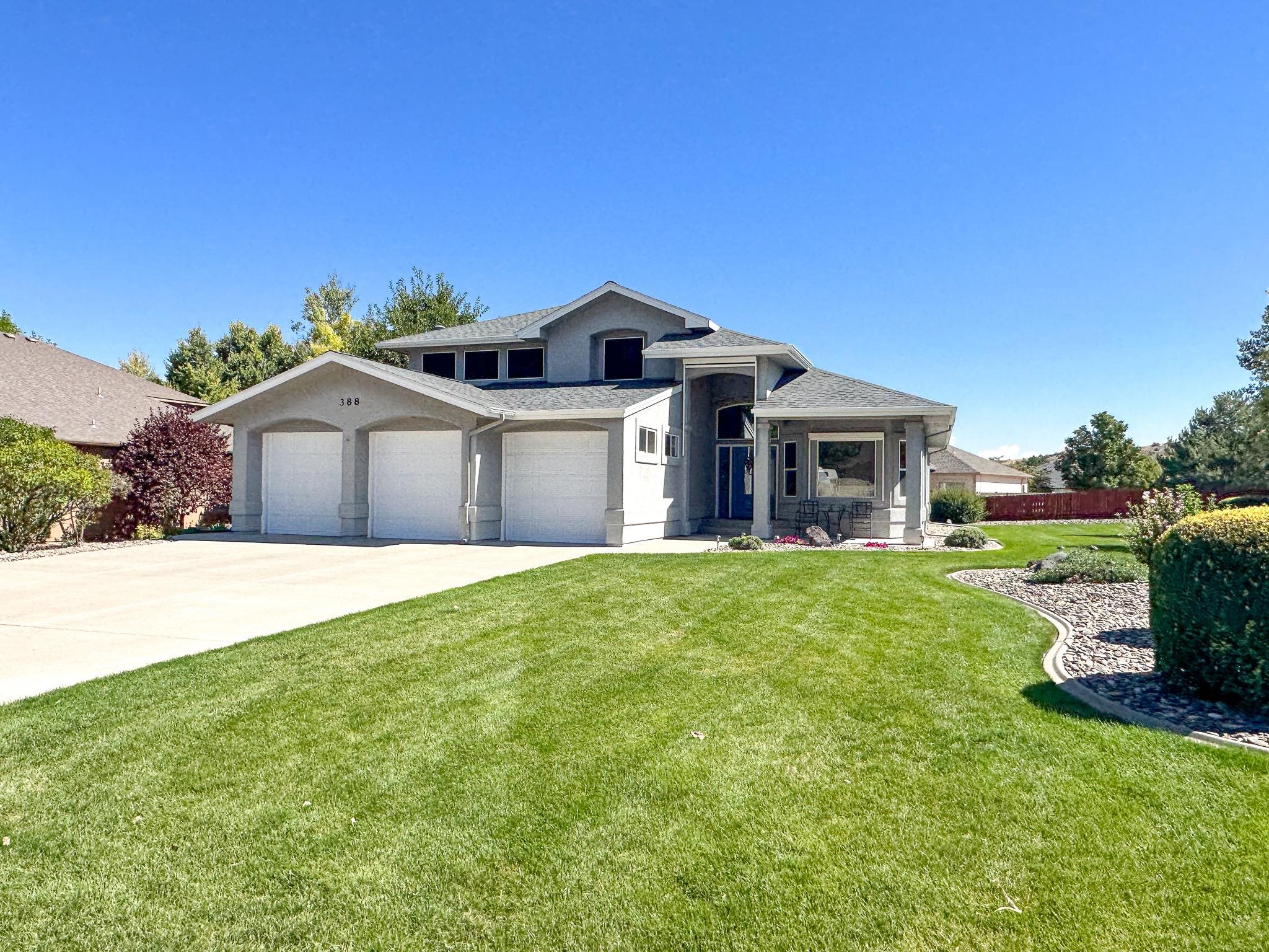 Welcome to this beautiful 3B/2.5BA home nestled at the base of the Colorado National Monument in the prestigious Visa Del Canon neighborhood! This spacious 2,425 square foot home features 3 bedrooms, a large office, two living rooms, and an open concept kitchen perfect for entertaining! When you walk into the towering foyer you can turn and gaze up at the revered red cliffs that flank the Monument. A well equip office is directly off of the foyer, with a half bath located conveniently across the hall. Access to the dedicated laundry/mud room comes off of that hallway as well. In the heart of the home you will find a large kitchen with ample cabinetry and countertop space, plus a pantry! The dining room and main floor living room are flooded with light from the towering two story wall of windows, and a gas fireplace helps keep things cozy. Access to the back yard and fantastic concrete patio is off of the main living area. Tucked away from it all on the main level is the primary suite, complete with beautiful windows and a 5-piece bath. The walk in closet is exceptionally large and has excellent built-in storage. Upstairs you will find a second living room, two spacious spare bedrooms, another full bathroom, and a flex space that could be used as another office, a small home gym, or extra storage. Outside this property is impeccably landscaped and has mature grass and plants. Irrigation water provided through the HOA helps keep everything looking lush! Concrete sidewalks surround the entire home, and the back patio is ideal for relaxing or hosting. The 3 car garage provides tons of added storage space. The home is heated via natural gas fired hot water baseboard heat, and cooled with a high end swamp cooler. There are also numerous sun shades that come down over the outside of many windows to help with energy efficiency and temperature control. All of the windows have a UV protectant glaze on the outside. The neighborhood offers wide streets, ample sidewalk space, open space, and walking paths. Located just minutes from town, this location is highly convenient yet isn't plagued by the hustle and bustle. Don't miss out on all that this incredible home and neighborhood have to offer!