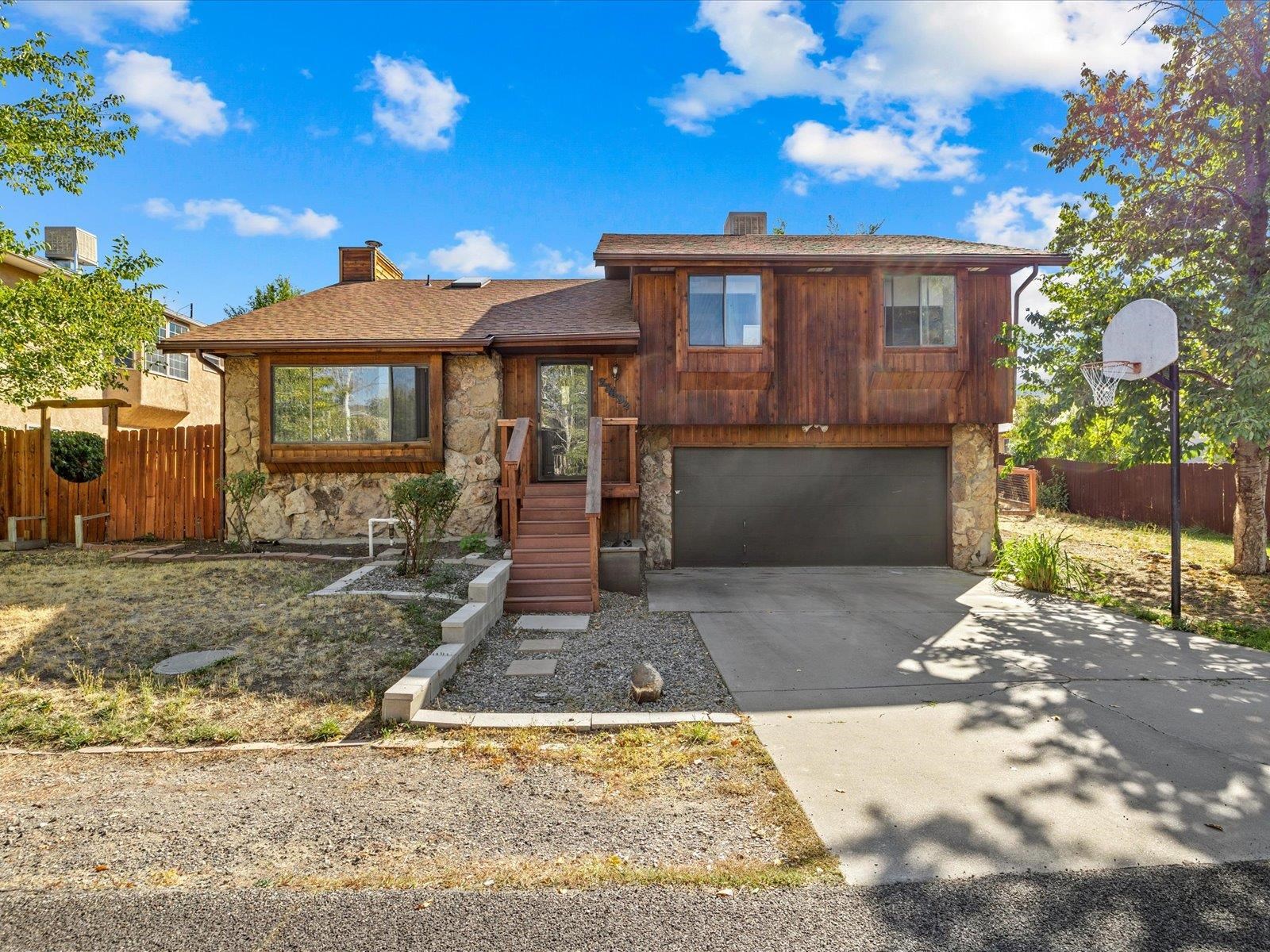 This inviting home is nestled in the charming Redlands community. On the main level of the home you will find two bedrooms and two baths which includes a spacious primary suite that has a walk-in closet. The second bedroom is generously sized, originally designed as two separate bedrooms, but a previous owner cleverly removed a wall to create a versatile space, transforming this 3-bedroom home into a comfortable 2-bedroom layout. The finished basement is a flex space, offering options for a second living area, a home gym, an office, or whatever suits your lifestyle. There is a 1/2 bath, utility closet & more storage room available in the basement. Luxury vinyl plank floor runs throughout the main living area & bedrooms. The fenced backyard provides an opportunity for you to build out gardens. Recent improvements include: new roof & skylight (2017), back deck replaced with composite decking & vinyl railing (2022), dishwasher replaced (2022), exterior sealed with linseed oil (2023). The location offers a perfect blend of outdoor recreation and convenient amenities. The Lunch Loops Trail System, Redland's Golf Course, as well as the community pickleball, tennis, and volleyball courts, & kids' playgrounds are a short distance from the home. Restaurants, shopping and downtown Grand Junction are conveniently located within a couple of miles. Be sure to check out the virtual tour available!