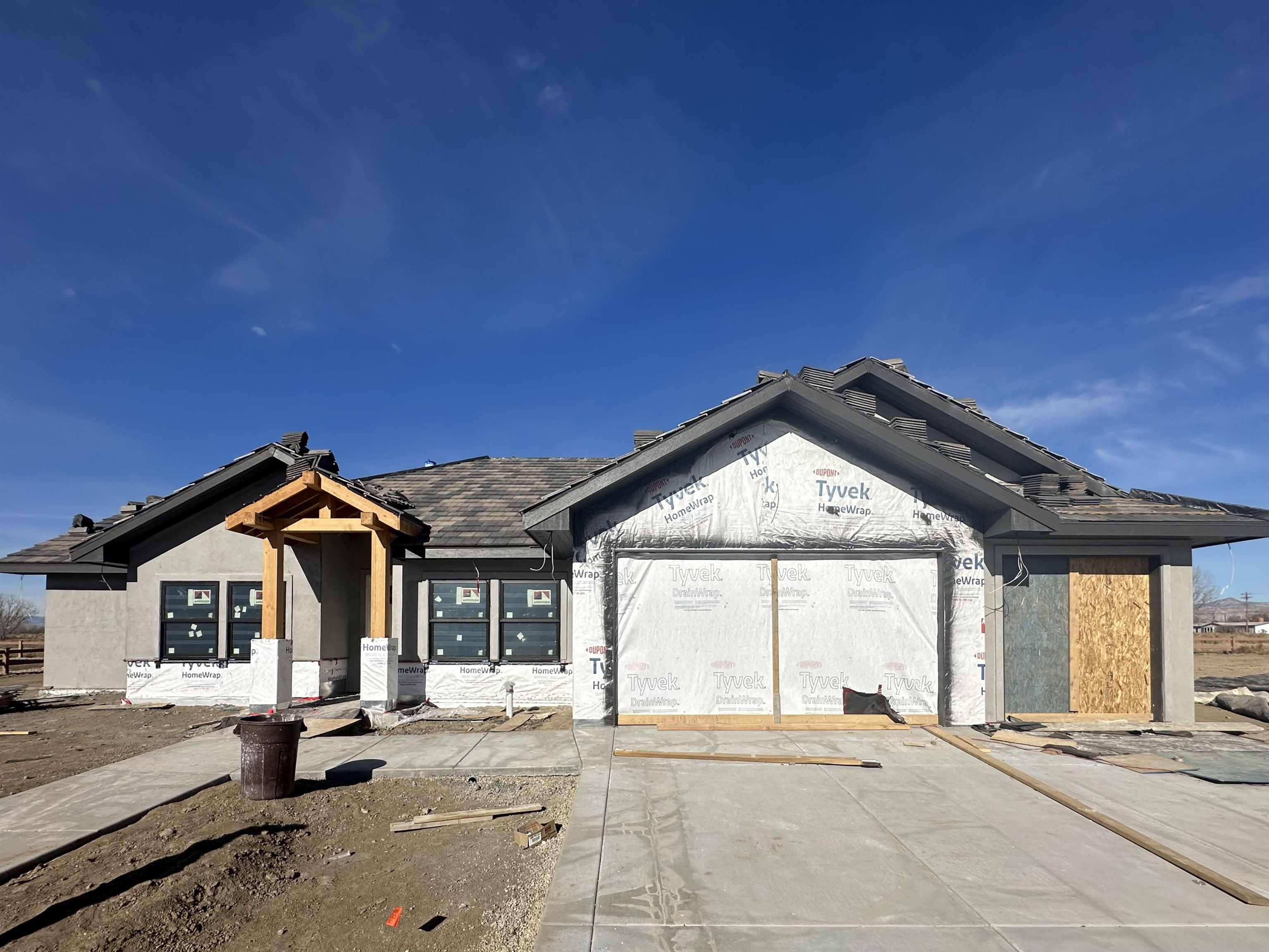 Beautiful new construction in Adobe Falls by award winning Builder, TreyTyn Homes! This stunning split-bedroom floor plan features an open and inviting layout with plenty of upgrades throughout! As you walk in through the covered entry, you are ushered into the foyer with 10' ceilings that add to the grand and open feeling. 4th bedroom/office and powder room sit at the front of the home, for guest privacy or quiet workspace. Two additional bedrooms on the west side of the home are generously sized and share full bathroom that features custom cabinetry and stylish tile accents. Open concept living, kitchen and dining space spans the north end of the home and is flooded with natural light through a wall of LowE windows and sliding glass doors. 11' tray ceilings add dimension and character to the inviting space! A masterpiece kitchen offers large center island, abundant cabinetry, solid surface countertops (material TBD) and attractive tile backsplash. Walk-in pantry with charming barn door for plenty of storage space! Primary suite is tucked away on the Northeast end of the home and features en-suite 5 piece bath with dual vanities, walk-in shower with custom tile, freestanding tub, private lavatory and oversized walk-in closet with built-in shelving! Enclosed laundry room AND adjacent mud room area off the garage with cabinets and storage bench add functionality and smart space utilization. Large covered back patio to enjoy outdoor living and incredible Grand Valley views! Adjacent to Adobe Creek Golf Course and just a short distance to Fruita's renowned hiking & biking trails for the outdoor enthusiasts to relish in! Nearby top-rated schools and a growing community of thriving restaurants, shopping and entertainment just a quick trip down the road. You'll be sure to enjoy this incredibly designed home with magnificent curb appeal for years to come!