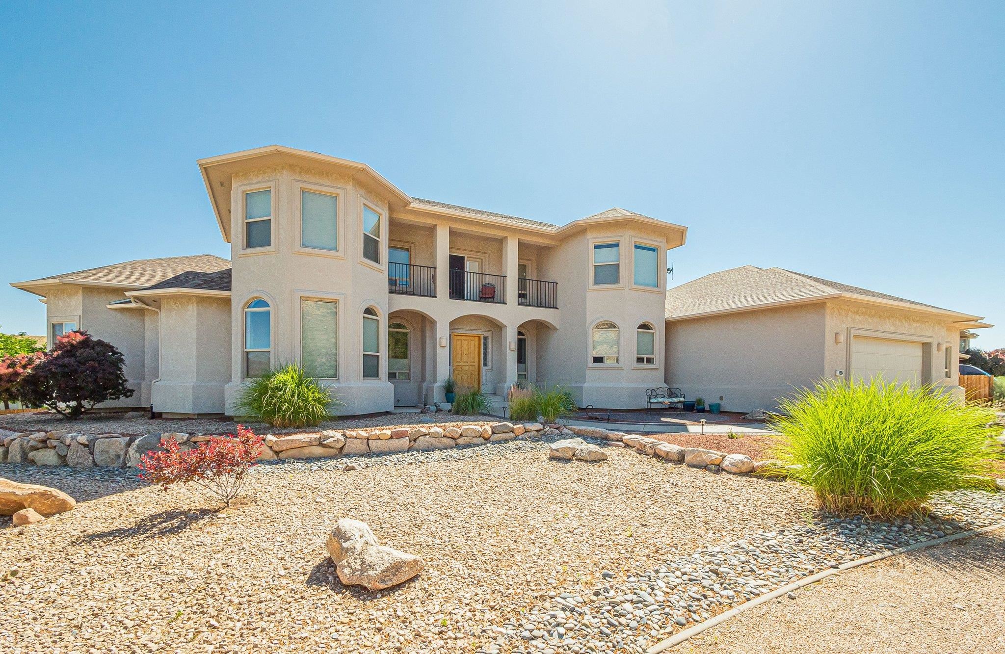 The Colorado Dream is calling! Soak in the views of the Colorado National Monument from this 3826 SqFt custom home.  Built in 2004 with one owner. This Two-Story home features: 4 Bedrooms, 3 1/2 bathrooms and 2 car attached garage with workshop (could be 3rd car bay) & RV Parking. The Main level includes: primary bedroom with french doors to covered patio & hot tub, guest room with attached bath, library, guest bath, formal dining room, kitchen/walk in pantry, great room with fireplace, eating area and access to backyard.  Located on the second level is two generous bedrooms, full bath and small balcony to take in those views!  Outside you can enjoy that morning coffee or evening wine on the covered back patio overlooking your own private garden outfitted with fruit trees and grapevines.  This is the perfect home base for all your recreation desires: hiking the Colorado National Monument, numerous bicycle trails, winter skiing at Powderhorn, summer rafting down the Colorado River,  and so much more.  Isn't time to start living the life you desire?