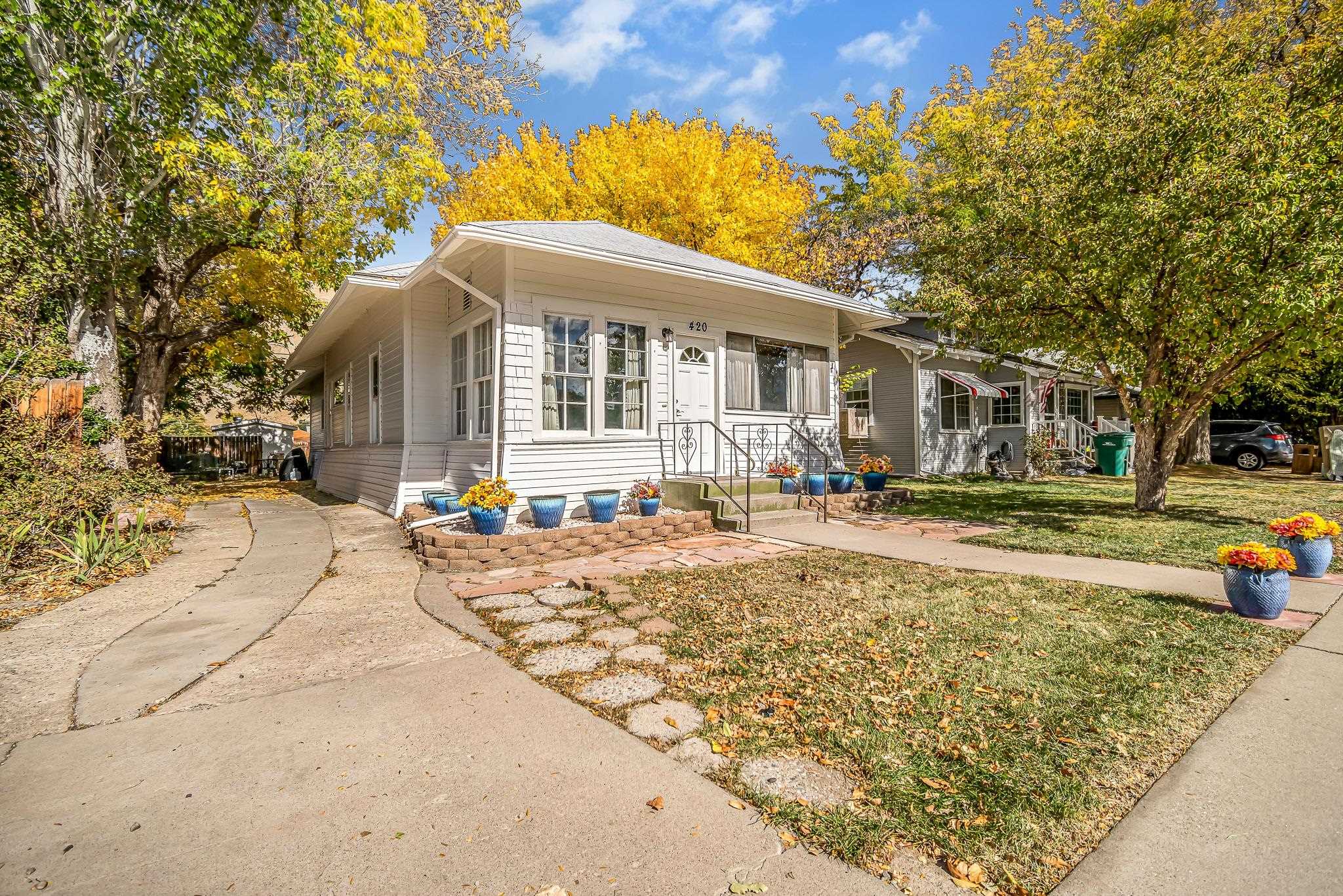 This charming downtown bungalow is located in the heart of Palisade, just steps from downtown shops, restaurants, its award winning farmer's market, wineries, breweries, and Peachbowl Park. The home retains its original charm from the moment you step into the cozy, bright sitting area, accompanied by 3 bedrooms, 1 bathroom, and a large storage space downstairs. It still has plenty of room to add your own mark with updates, but sellers have maintained the home well over the last several years with a freshly painted exterior, updated electrical, plumbing, insulation, newer laminate flooring, etc. Downstairs one will find ample storage space with built-in shelves and a workshop bench to utilize for projects. Additional storage can be utilized in the spacious 16' X 10' shed located in the quaint backyard that is accompanied by stunning views of the Bookcliffs. This location is prime for a primary residence, Airbnb, investment, or secondary property.