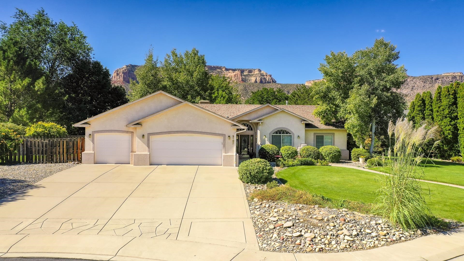 Charming ranch-style home on an established cul-de-sac lot in Canyon View; a highly desirable Redlands location! Immaculate curb appeal reflects pride of ownership with expertly manicured landscaping, mature trees and shrubs and a wonderfully up-kept & durable stucco exterior! Through the glass door front-entry, you're ushered into the grand foyer with vaulted ceilings and unique half-moon window accent! Behind french doors lies the privately situated front office area, which could also be used as additional bedroom, with plenty of closet space, large picturesque window and built-in architectural shelving for decor display! Open living and kitchen area is perfect for both entertaining and easy living! Cozy gas-log fireplace adds additional warmth and ambiance to the living space, and built-in hearth with shelving and accent mirror add an additional design and functionality element! Eat-in dining space adjacent to the kitchen allows for comfortable eating space overlooking the backyard space through bay windows that flood with natural sunlight! Well-equipped kitchen with plenty of cabinet storage, pantry area and a vaulted ceiling with even more shelving accents for architectural dimension! Primary bedroom boasts an oversized walk-in closet and en-suite bathroom, complete with dual vanities, jetted soaker tub and enclosed walk-in shower. Two additional comfortably-sized bedrooms offer abundant closet space, architectural accents and share a full bathroom with tile surround tub/shower combo and a spacious vanity! LARGE laundry room off the garage entrance, for convenience, offers cabinet storage and hanging rod for laundry ease. Backyard OASIS is a SHOWSTOPPER! Open patio area in addition to a pergola covered area, that's perfect for outdoor gatherings, entertainment and meals! A lush landscape of mature shade trees create a picture-perfect canvas with the stunning backdrop of the Colorado National Monument that encapsulate incredible views for years to come! Irrigation water provided by HOA for ease of watering and utility savings! 3-car attached garage with potential RV parking space for all your car/vehicle storage needs!