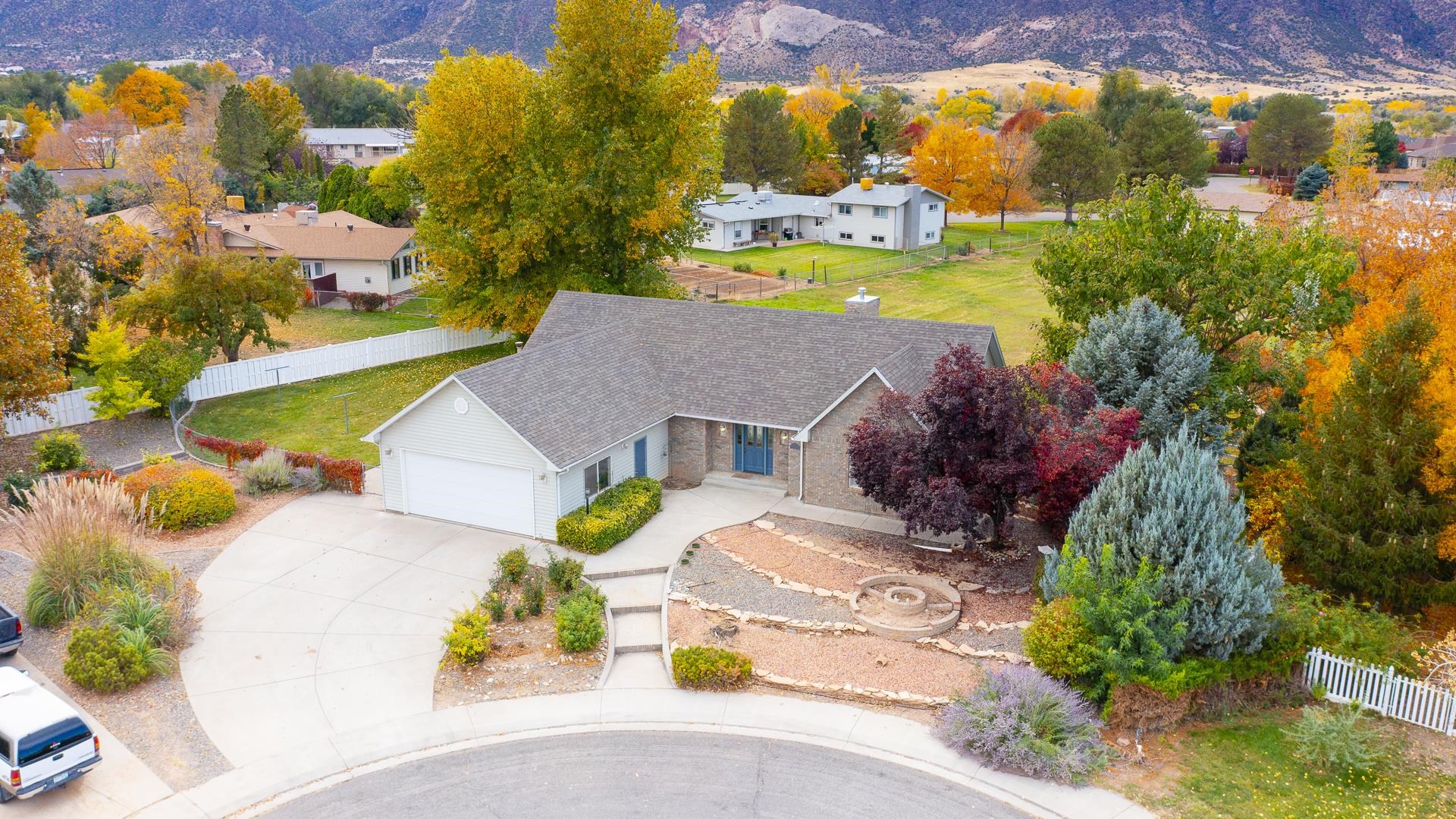 This scenically supreme Ranch style home is situated on a cul-de-sac, with beautiful views of the Monument as you sit on the deck that overlooks a lush field. Lots of windows from the living/family room also captures the views. Compact size kitchen with some newer appliances, with large pantry adjacent. Brand new roof in October of the year, exterior metal siding for low maintenance which includes facia and soffits. Master has double vanities and large walk-in shower and closet. 3rd bedroom has a walk-in closet. The mature landscaping on this 0.37 size lot is all part of the beautiful setting and is meant to be enjoyed.