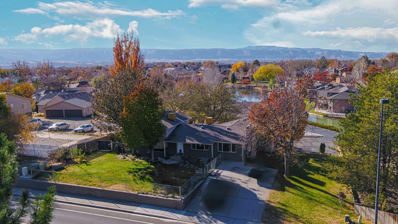 ASSUMABLE LOAN available at 2.25% INTEREST RATE for a large portion of this homes purchase price.  Home is priced under market value in hopes to close this sale as quickly as possible.    This North area home offers both the Elegance of the Crest View Subdivision complete with lake views from your back porch, as well as functionality with easy access to a driveway off of 27 1/2 Road.  This is a one of a kind find in the North area with lots of room for everyone both inside and outside the home.  Sit on your back porch or covered patio and enjoy the tranquility of the lake with a year round fountain or enjoy the multiple levels in this home with over 2500 sq ft of living space.  Solar on the home has been paid in full.  This home truly has it all.  Call me today to schedule your showing and don’t forget to ask for more details on this amazing opportunity to get a loan with a  2.25% INTEREST RATE!!!!