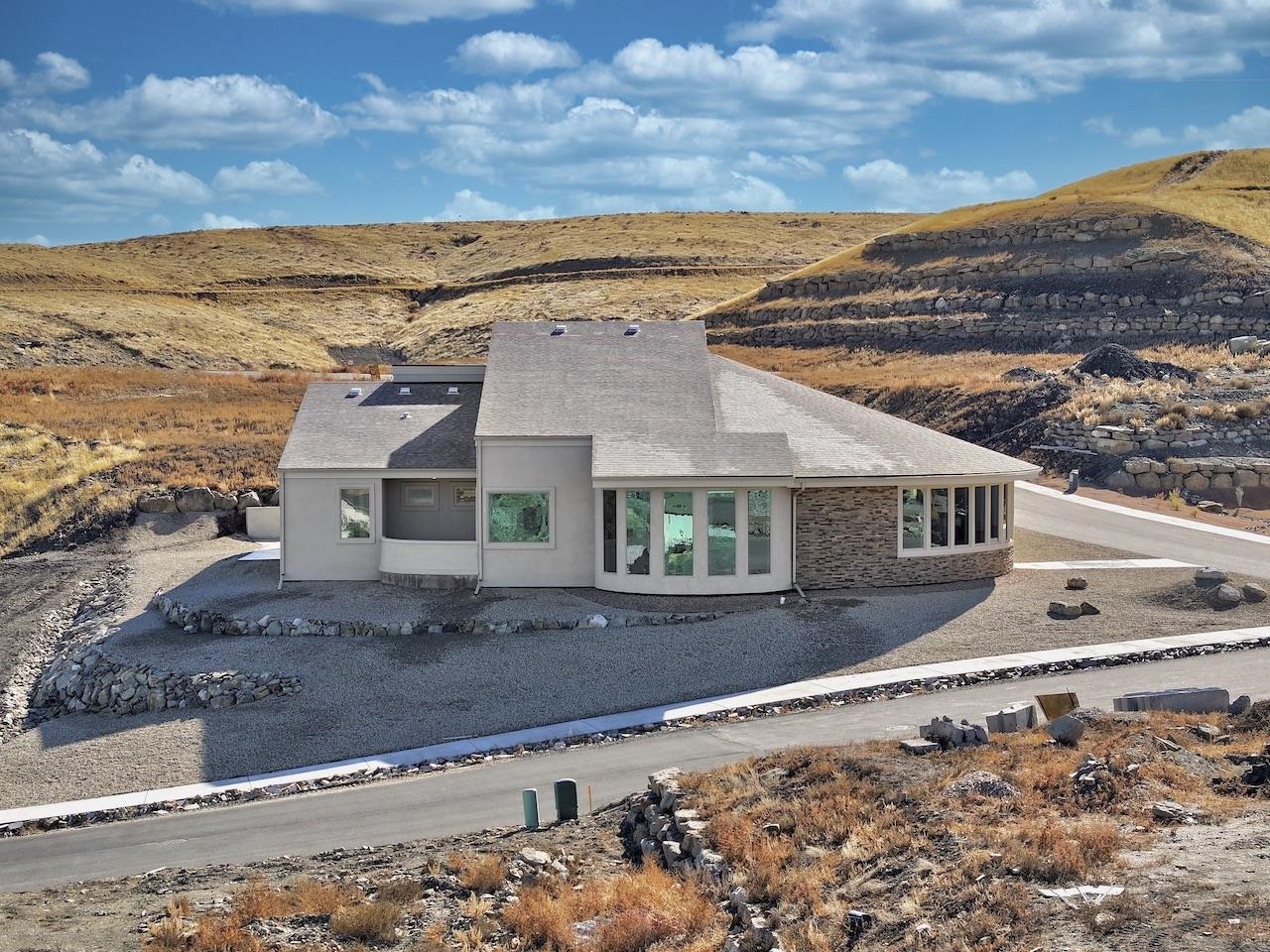 Architectural Beauty - 2873 squarefoot ranch style home with spectacular views, close to hiking, mountain biking trails, and next to the Colorado National Monument. RV area - 4 Bedrooms or use one for an office - 24x36 3 car garage with furnished floors, and desert landscaping to make a convenient lock and leave. Artistic architectural design to display your treasures. Doorbell security camera installed.