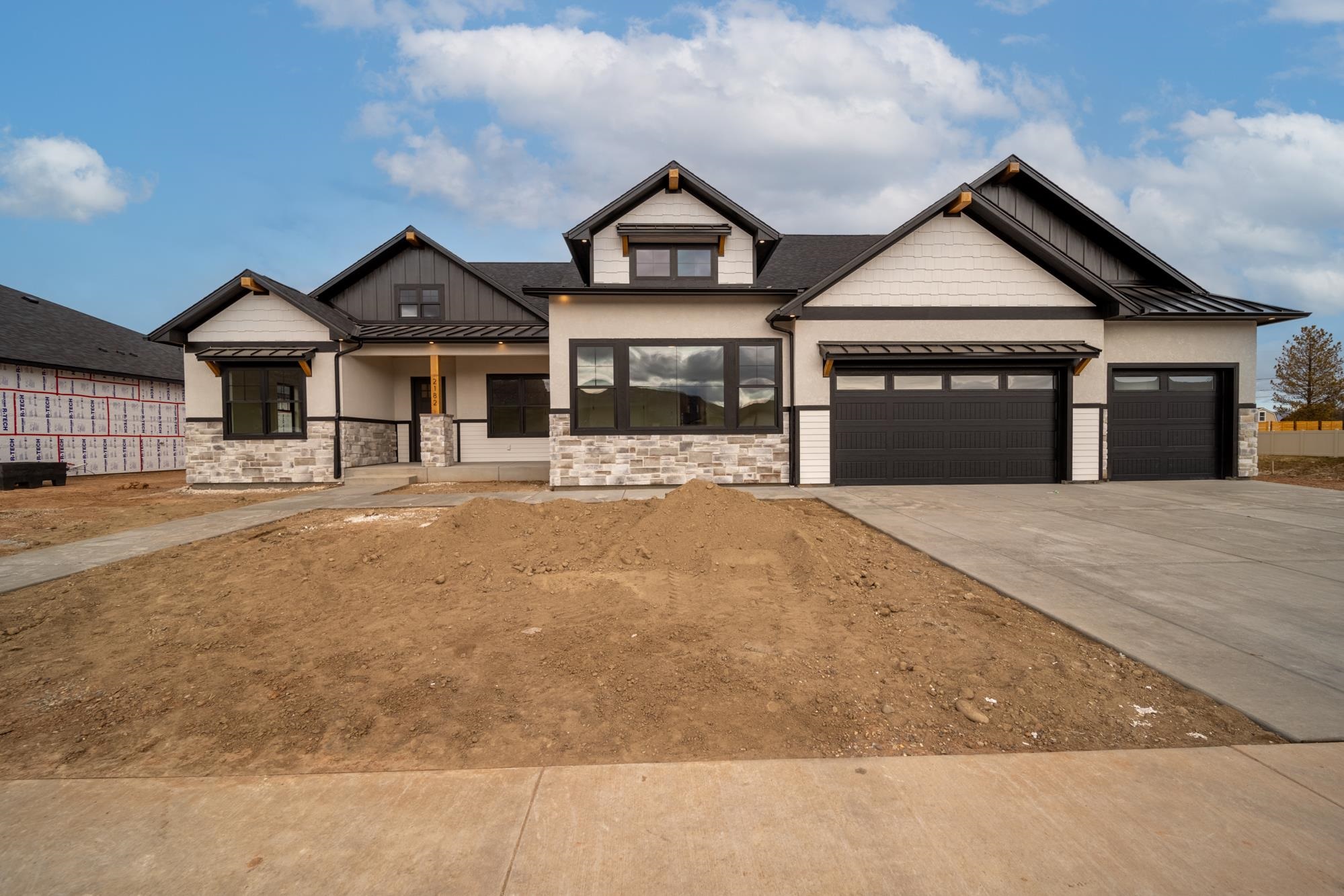 Stately home boasting a masterful design in a coveted community that sits at the base of the Colorado National Monument with an exterior facade that grabs street-side attention! This new construction home by Award Winning Builder, TreyTyn Homes, features a custom feel that checks off a wish list box for everyone! A thoughtfully designed floor plan with a split-bedroom layout offers primary privacy and entertaining space to enjoy the best of both worlds! As you enter through the grand front entrance, there lies an office/4th bedroom for easy guest access with 3/4 bath featuring oversized walk-in shower with bench seating and custom tile accents! Further steps will usher you into the expansive living area with cozy & ambient electric fireplace and rows of oversized windows that floor in natural sunlight! Premium kitchen to delight every home chef & mixologist between the Casa Bella Quartz counters, premium shaker cabinetry, tile backsplash and top-line stainless appliance package! Butler's pantry with rows of shelving and countertop space for meal prep, overflow storage and small appliance placement! Adjacent dining area is large enough for those large holiday family gatherings and convenient enough for the quick weeknight meal! Primary suite on east wing of the home features HUMONGOUS walk-in closet and en-suite spa-like bath with dual vanities, oversized walk-in shower and private lavatory closet. Pass-through access from walk-in closet to laundry area for added convenience and ease-of-operation! West wing of the home features two additional spacious bedrooms that share full bathroom with the same upgraded cabinets, counters and unique tile accents throughout! Expansive backyard space to enjoy the picturesque Grand Valley views and enjoy in the mild climate on the large covered patio. RV parking space on lot; no need to store your recreation vehicle elsewhere! Builder provided full vinyl fencing and front landscaping for added value and move-in ready feature! Full tapestry of hiking and biking trails nearby and just a short distance to Redlands Mesa Golf Course; the most perfect and serene community for the elevated outdoor enthusiast to reside!