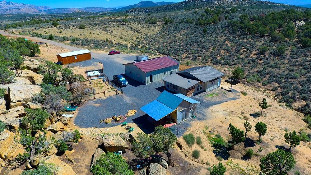 Have you been looking for a property that offers quiet, sustainable, off-grid living? Located on 40 acres approximately 40 minutes from Grand Junction and 15 minutes from De Beque Colorado. The main cabin offers 1140 square feet, 1 bedroom, 1 bathroom, kitchen, living room, dining room and utility room. A 24 volt solar panel system, 1000 gallon septic and a 1700 gallon cistern feeds the main cabin. The smaller cabin is 360 square feet with a studio apartment. A 12 volt solar panel system, 500 gallon septic, 1000 gallon cistern feeds the small cabin. There are 2, 500 gallon propane tanks (1 owned & 1 leased) that feed the main cabin, small cabin and shop. The 33x35 shop has 2 generators; 1 on propane and 1 on electric. Shop has 220 volt power, forced air heat and a wood burning stove. The property adjoins BLM land in the SW corner and the NE corner of the property. 4 wheel drive is recommended in the winter & spring months.