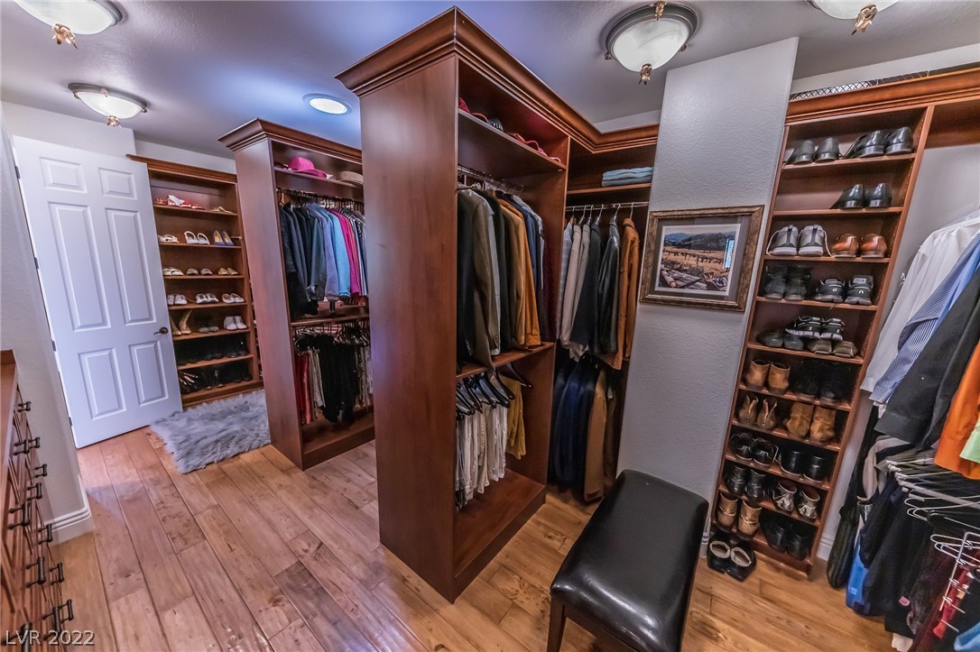 Owner's suite custom closet with two entrances.