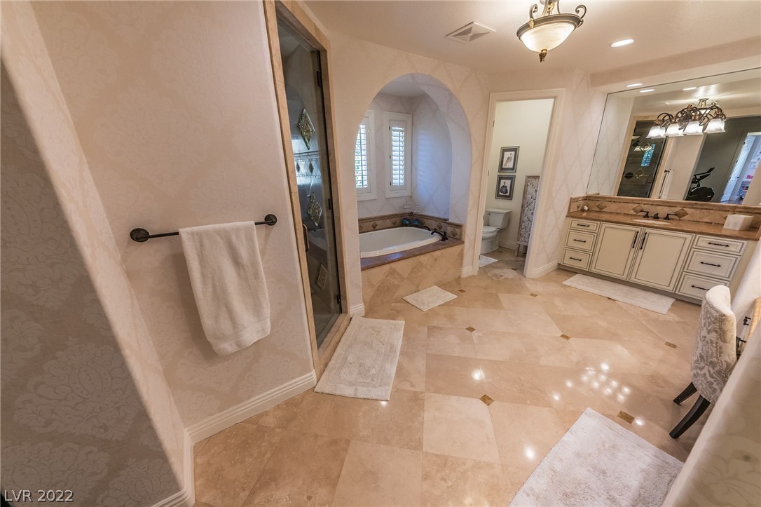 Owner's suite with make up vanity, dual sinks, soaking tub and stand alone shower.