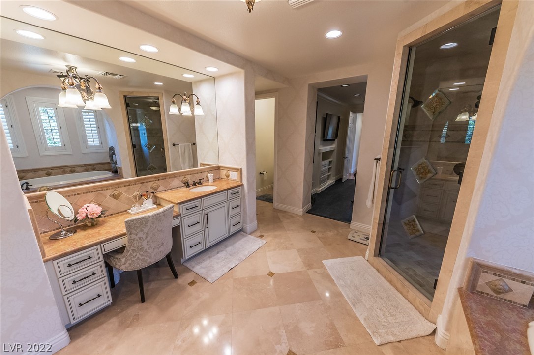 Owner's suite with steam shower, make up vanity and dual sinks.