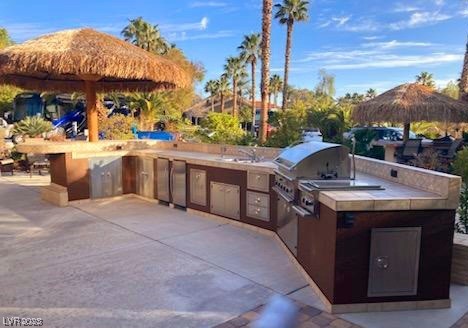 Located within the Class A Las Vegas Motorcoach Resort, this fantastic North facing site has privacy!  This cozy site features an outdoor kitchen with stainless steel appliances, palapas for shade, elevated dining area, storage shed, lush landscaping, and much more!