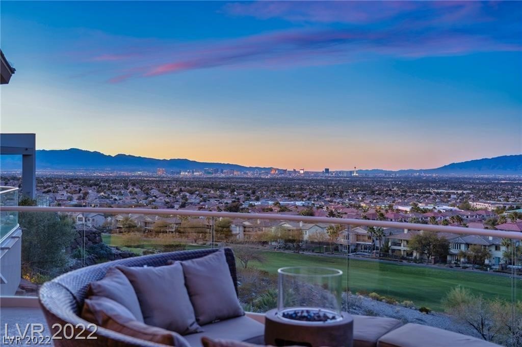 View Trifecta! Picture Perfect Strip, Golf, & Mountain View from Every Room! Located in Luxurious MacDonald Highlands and within the Guard Gates of Dragon Ridge Country Club, this home features QUALITY T/O after a recent 2 Year, $2M Renovation. Courtyard Entry w/Koi Pond, Waterfall, Great Room w/Bright, Open Kitchen featuring Electronic Cabinets, Subzero Appliances, Wet Bar, Glass Walls, & 3,500 Sq.Ft. of Covered Decks. Five Large En-Suites all with w/Floor to Ceiling Glass Doors, Patios, and Custom Closets. Two Primary Suites w/Stunning New Bathrooms complete Spa Tubs, Deluxe Steam Showers, Breakfast Wet Bars, 2 Toilets Each & Enormous Walk-in Closets. Lower Level has an Enchanting Theater w/Stage, Gym w/Steam Room and Changing Room, Temp. Controlled Wine Cellar with Tasting Room, Elevator, Entertainment  Room w/Curved Glass Sliders to BBQ/Summer Kitchen Deck, Pizza Ovens, Beach Entry 3-Level Pool, Waterfalls & 2 Spas! Gated Driveway to Double Garages w/ A/C, Built-ins & Workstation.