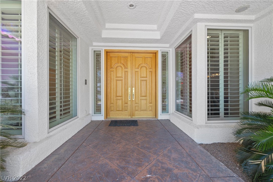 Covered porch double door entry.