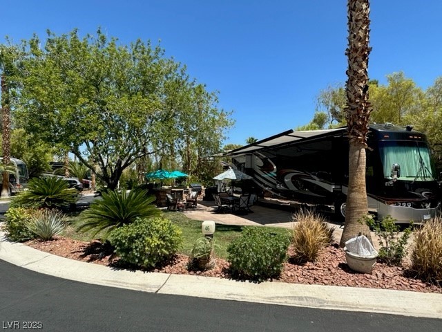 Located within the Class A Las Vegas Motorcoach Resort, this amazing, oversized corner lot is filled with mature lush landscaping, shade, and a full outdoor kitchen with stainless steel appliances, sink, storage, and granite countertops. Located in "Old Town" right around the corner from the Main Clubhouse, pool, and other amenities!