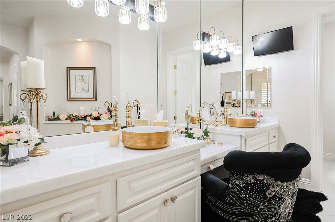 The Golden Touches on the Tub and Sinks add Elegance to the Oversized Room.