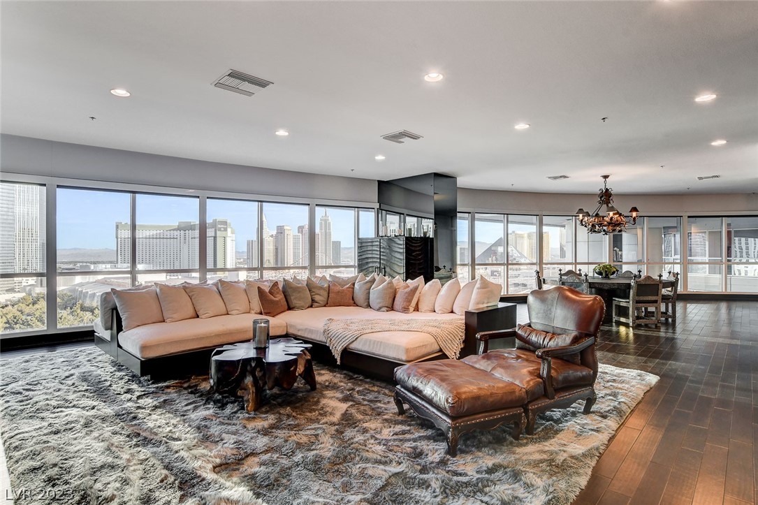 The epitome of luxury, high-rise living - Fully furnished, wraparound penthouse w/floor-to-ceiling windows offering unobstructed views of the famous Las Vegas Strip! From the moment you enter, this unit will take your breath away w/its abundance of natural light & designer finishes. Sleek, espresso flooring compliments the custom furnishings & matte ceiling. Chef's dream kitchen w/expansive counter space, Stainless Steel appliances (including stand-alone espresso & ice maker), breakfast bar, & W/I pantry. Nearby bedroom enjoys gorgeous views & private entrance - ideal for guest quarters! Junior primary features dedicated hall w/storage, en suite bath, & W/I closet. Show-stopping primary bedroom has no shortage of views - whether laying in bed, working from the attached retreat, or enjoying a glass of wine on the terrace you'll appreciate the twinkling lights of the most exciting city on Earth! Unit includes TWO *Covered* Parking Spaces + ultra-high end Panorama amenities!