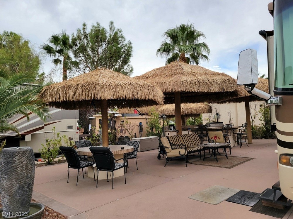 Located within the Class A Las Vegas Motorcoach Resort, this amazing, fully improved north-facing corner site is ideal for entertaining. Featuring a built-in barbecue, cooktop, refrigerator, sink and tons of counter space. The island is wired for sound with a built-in speaker system. There are three separate seating areas covered by three oversized palapas. The landscaping is lush and there is also a stand-alone storage unit.