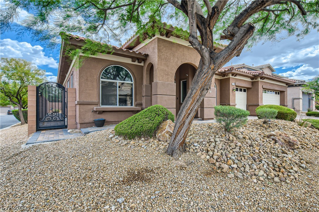 This fabulous 1 story on a 10,000 + sq ft corner lot in a gated neighborhood with a 3 car garage and a pool/spa is waiting for you!    Fresh paint inside, as well as new luxury vinyl plank flooring in the past year.  Other features include pavers on the driveway and walkway, new garage doors and wireless openers, Murphy bed in one of the bedrooms, ceiling fans in all the right places, closet organizer in the primary bedroom, fireplace and surround sound in the family room, patio cover, removable fence around the pool/spa, granite counters in the kitchen with plenty of cabinets.  The refrigerator is included as well.  You will also enjoy the water conditioner, an R/O system, an alarm system, central vacuum, new faucets in the primary bath & epoxy flooring in the garage.  The overhead storage racks in the garage will remain, as well as one large shelving unit. Mountains Edge master planned community features many parks, walking trails, restaurants and shopping.