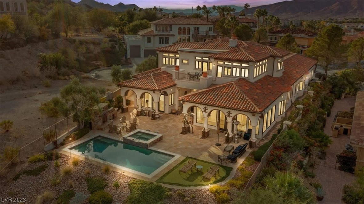 This residence exudes opulence through its timeless architectural design. Set in the Exclusive Guard-Gated SOUTH SHORE. A bold Executive Office greets you at entry. This lavish 5 BR retreat spans across 6,430 sq ft with views overlooking the 12th fairway of a private Jack Nicklaus Signature golf course. The chef's kitchen and butler's pantry are culinary sanctuaries equipped with Viking & Sub-Zero appliances such as 3 refrigerators, 4 sinks, 2 dishwashers, and a generously sized kitchen island. Stock the WINE CELLAR! The primary bedroom on the main level impresses with indoor/outdoor access to the Saltwater Pool & Spa, fireplace and breathtaking views of  the fairways. The upper-level has splendid LAKE VIEWS with a wrap-around balcony that seamlessly connects the game-room to two ensuites. One of the four garage bays has been transformed into a custom closet, adding a touch of elegance to this already remarkable residence.
A true testament to a grandeur lifestyle.