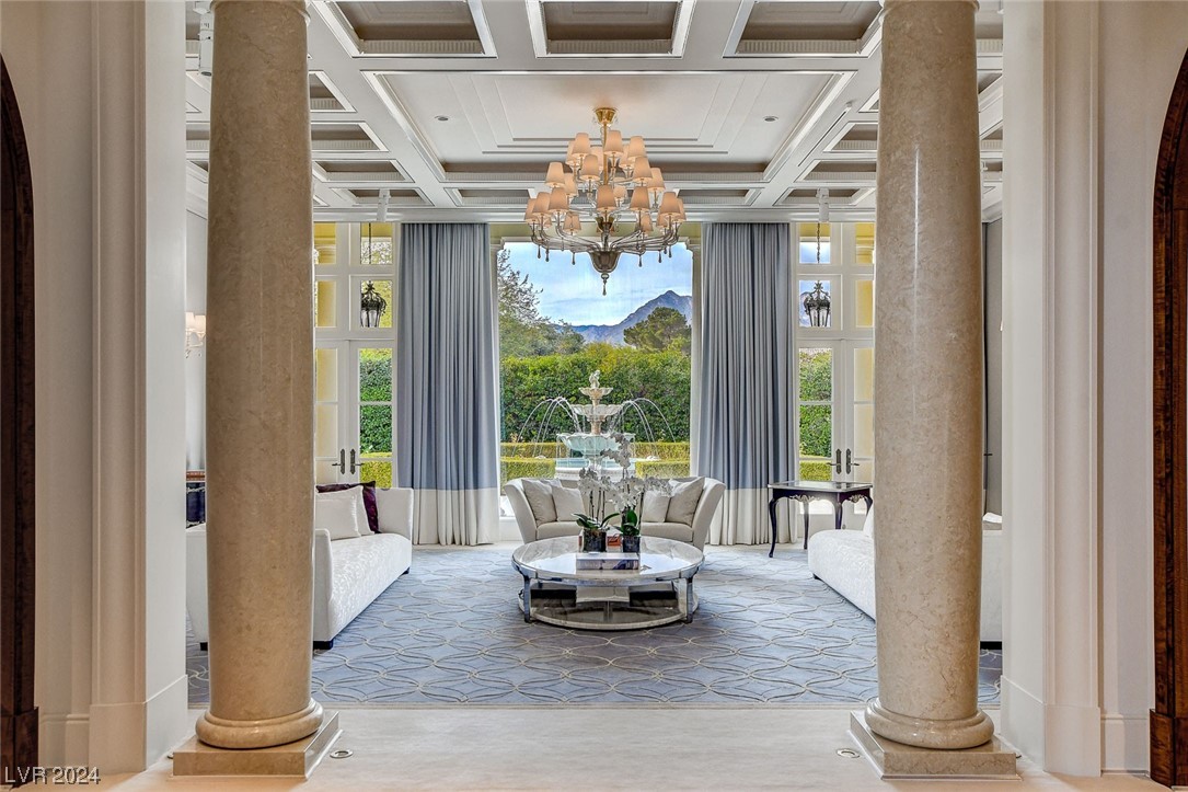 Formal Living Room over looking the garden waterfall.  Custom ceiling details, silk carpet and marble columns.